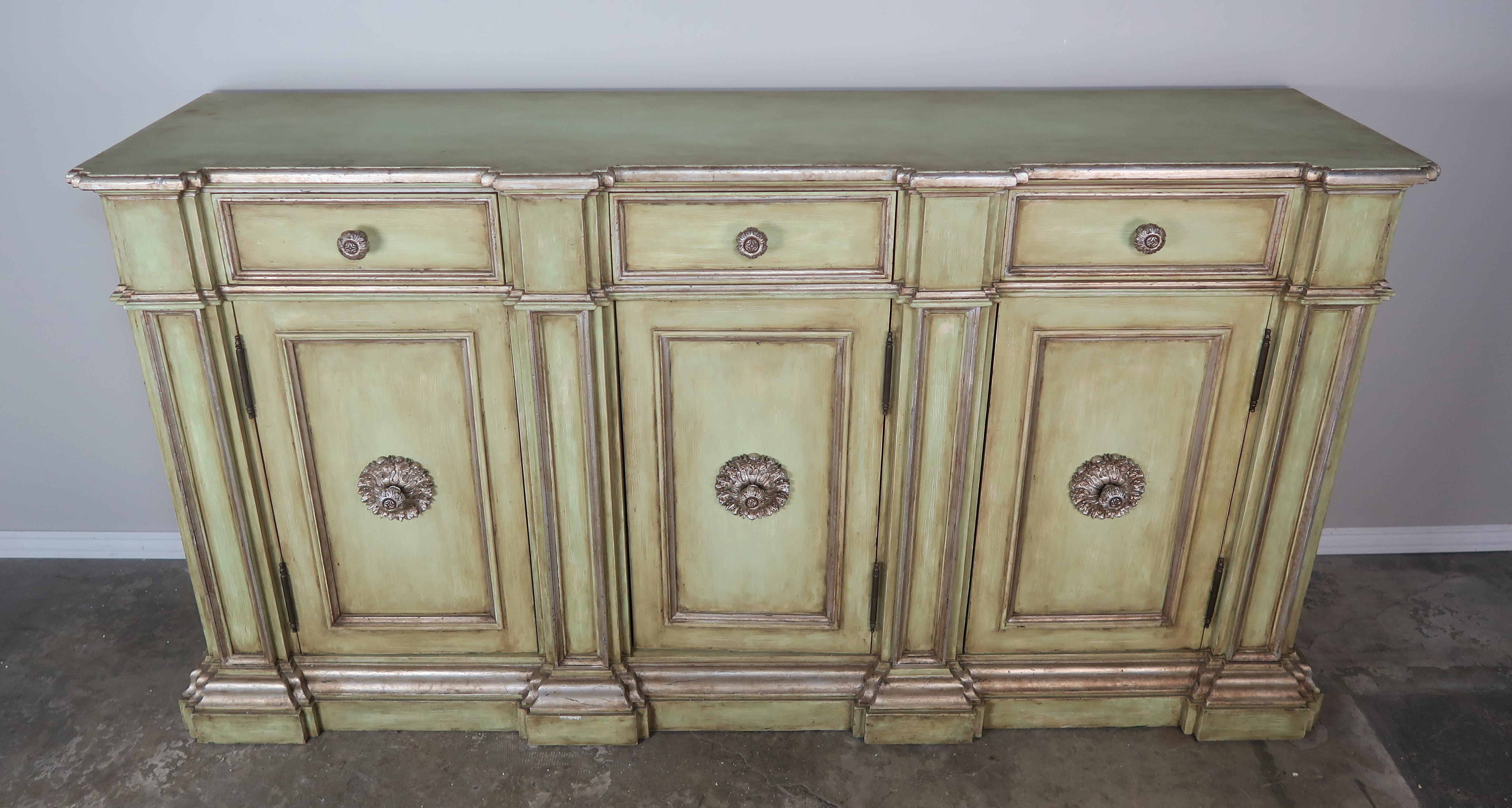 Italian painted neoclassical style credenza with doors with storage behind. There are also three drawers to accommodate storage as well. Beautiful carved round pull detail on all doors and drawers.