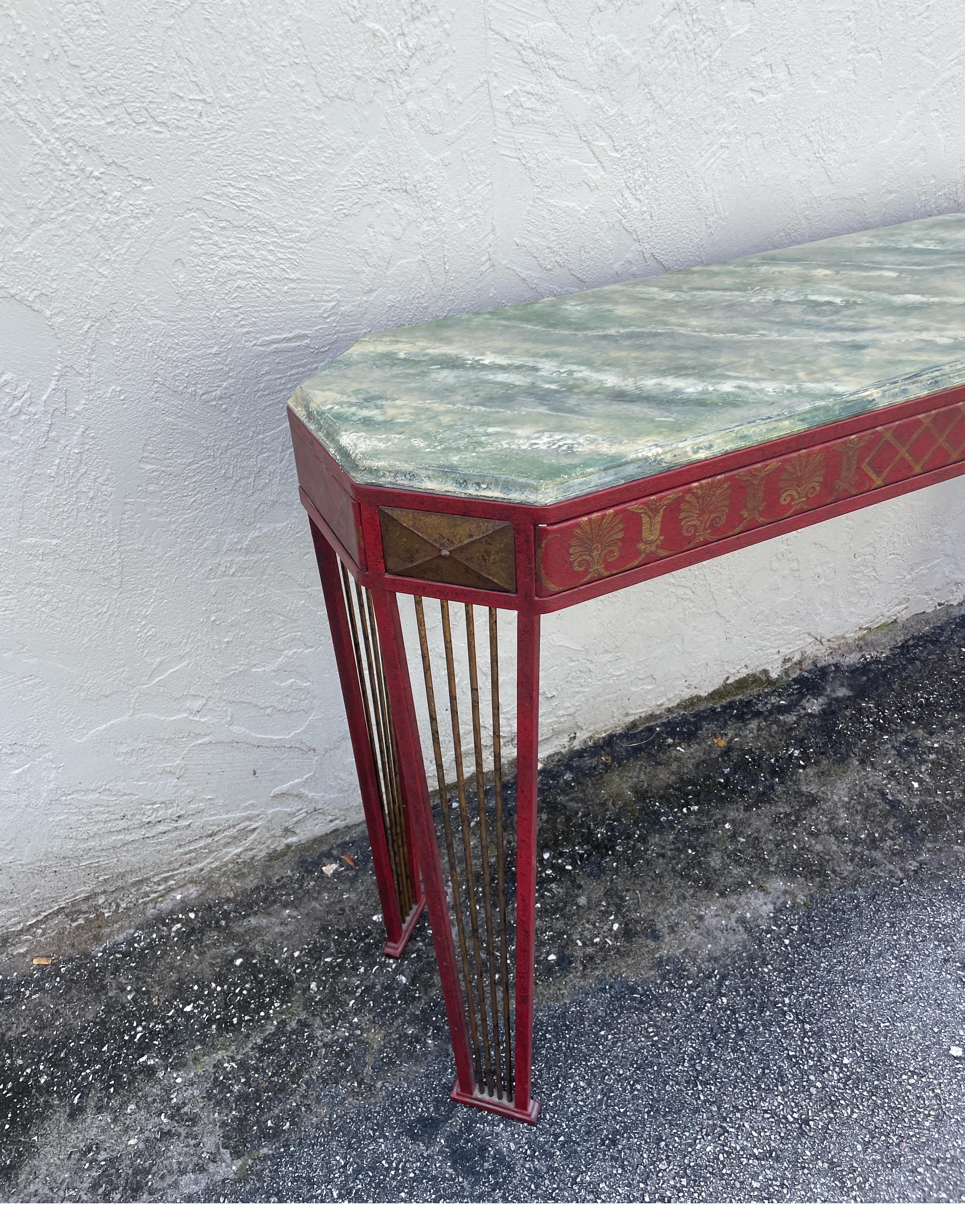 Very unique Neoclassical style hand painted tole console in deep red and gold. The top is wood & finished in a faux marble technique.