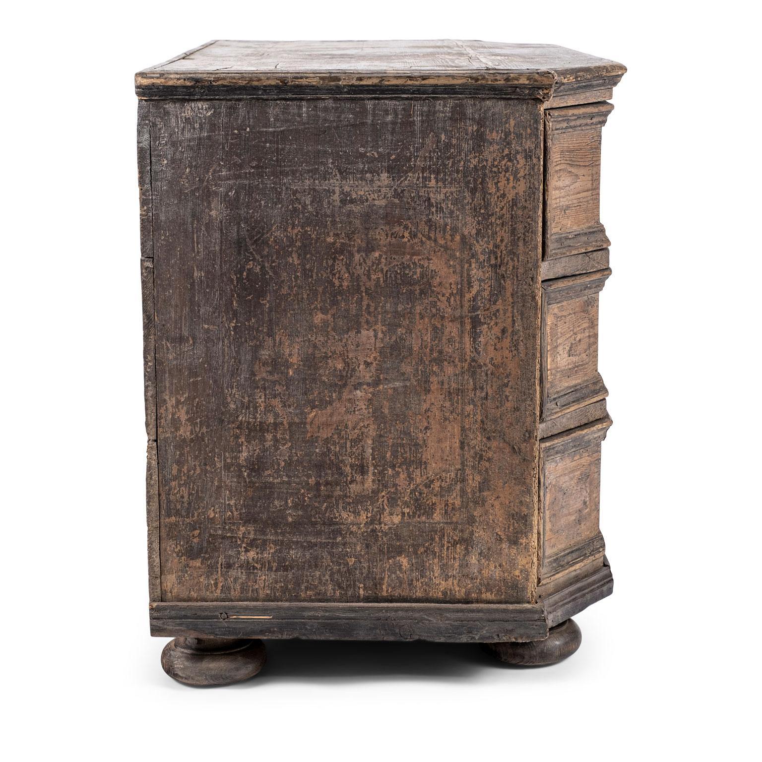 Large-scale Italian painted walnut commode dating to the 18th century. Large scale in mortise and tenon construction, raised upon bun feet. Scraped back to original or early paint. Remnants of early paint naturally worned to reveal beautiful walnut