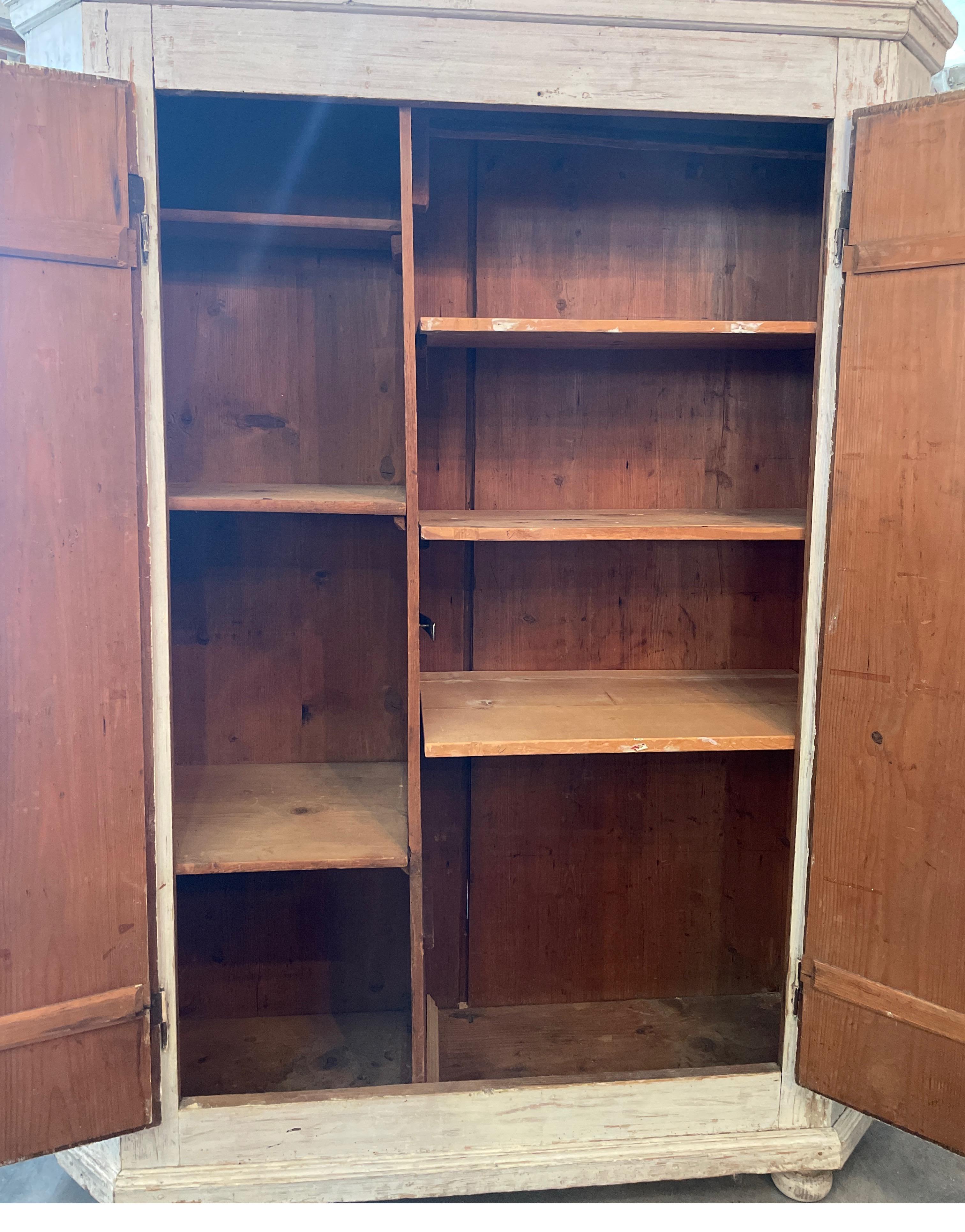 This is a smaller scale cabinet with lots of shelves and a bar to hang things. It’s from the Tuscan part of Italian and used for clothing storage. It’s key does lock the door.