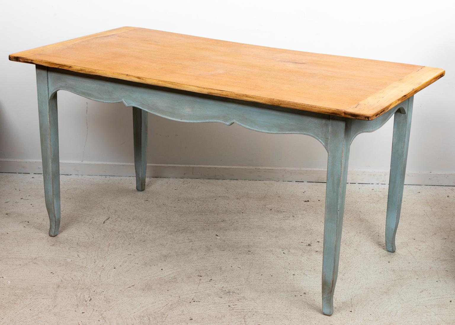 Circa 1940s Italian painted writing table or desk in the Italian Provincial style with three drawers on one side. The piece is painted in a light blue base with shaped apron and scallop trim molding. The top of the desk has been stripped revealing a