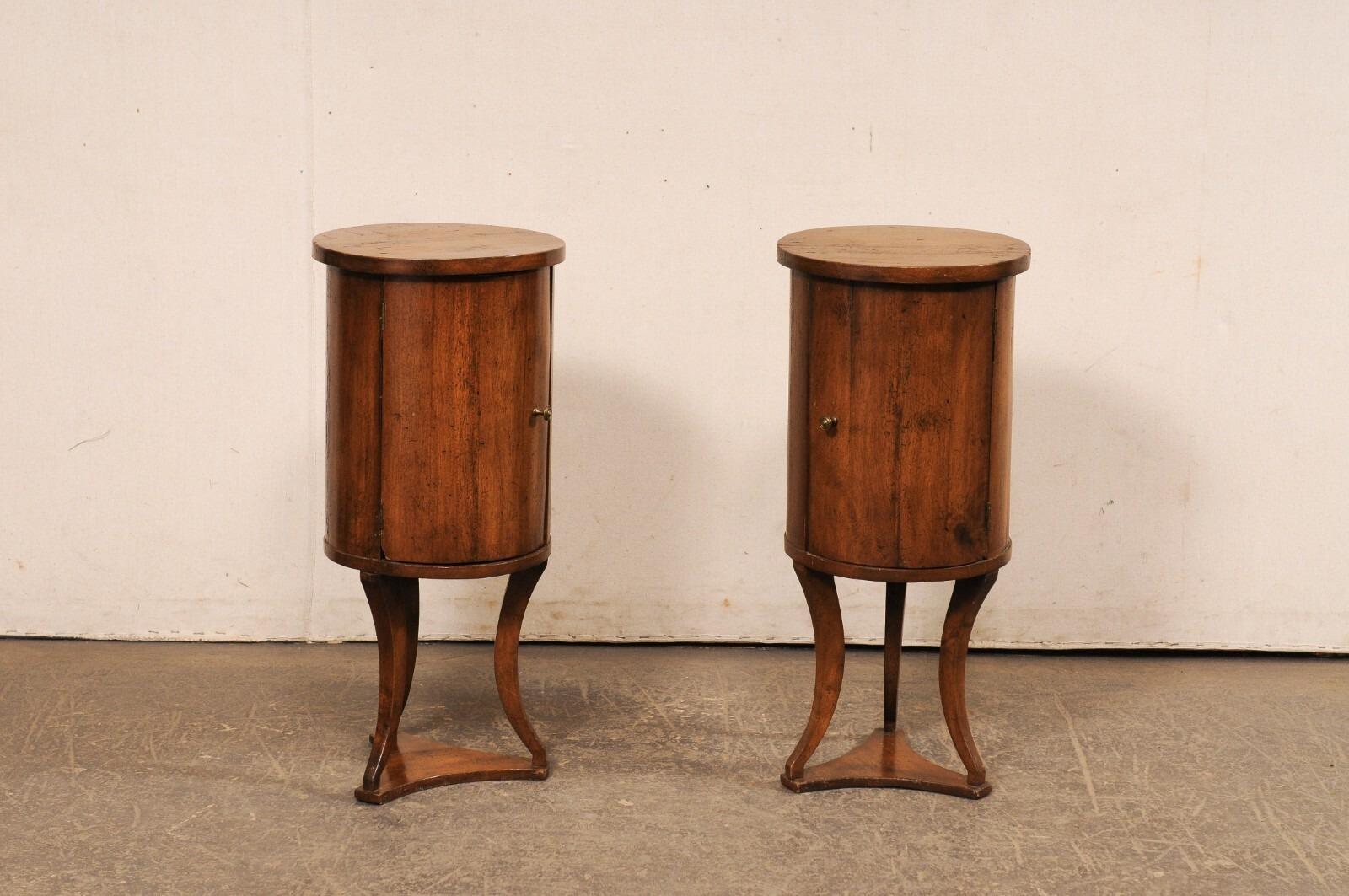 A unique pair of Italian wooden cylindrical end tables on triangular bases, from the early to mid 20th century. These antique tables from Italy have 14