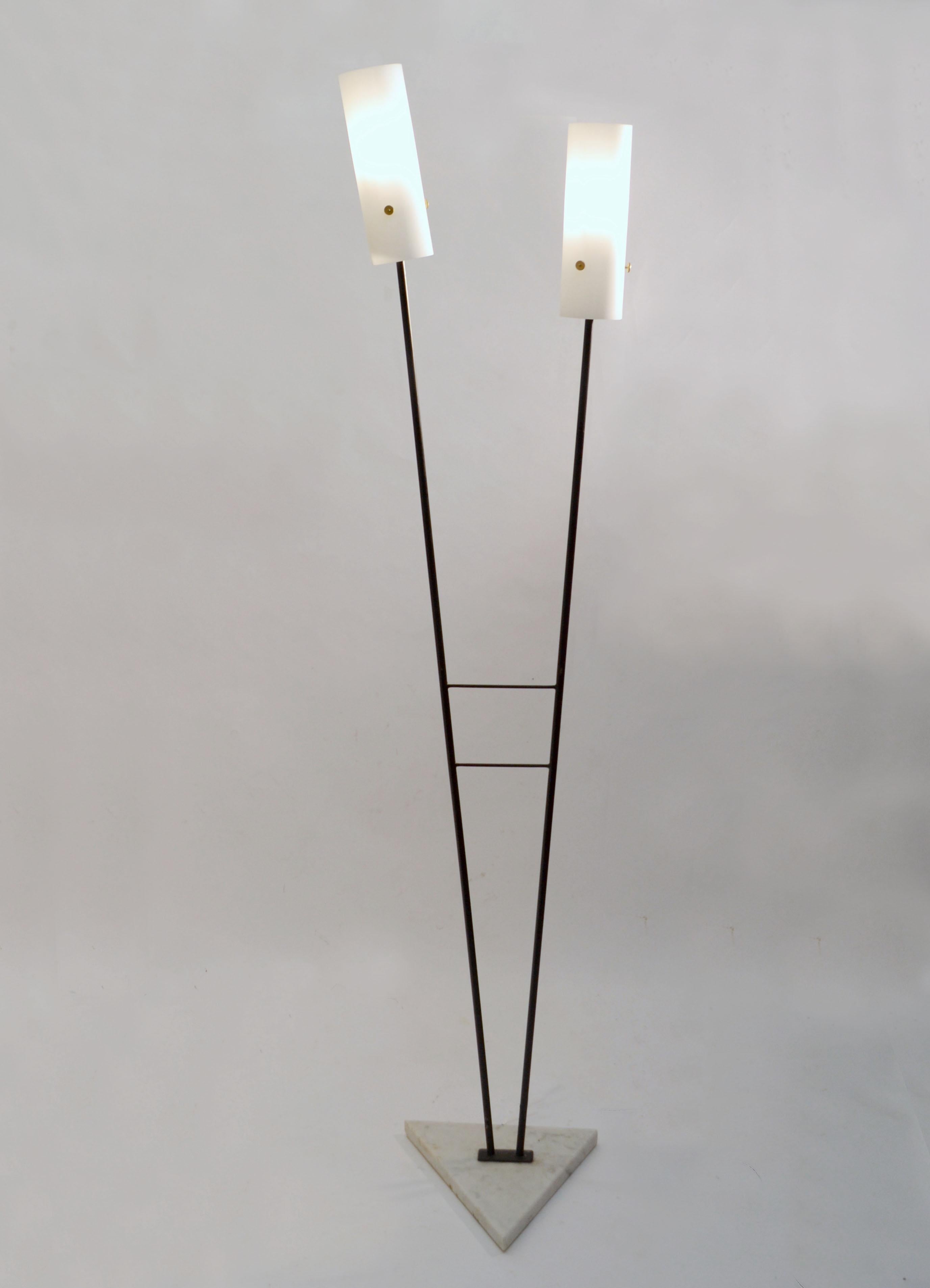 Pair of 1960's floor lamps with opaline glass cone shape cone shape shades and double V shape black metal stems lead a to on triangle Carrara marble bases. The black lacquered frame create a strong shaped geometrical silhouette. 
It is rare to find
