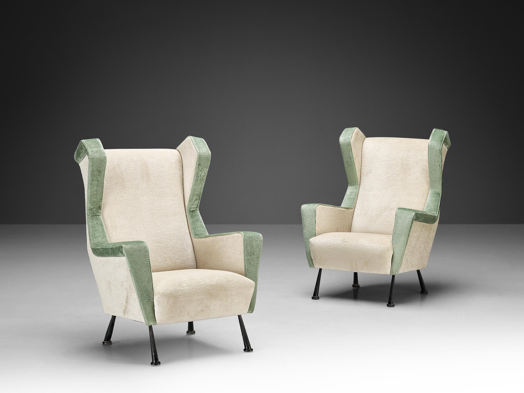 Pair of easy chairs, Pierre Frey 'Georges' velvet upholstery, coated metal, Italy, ca. 1950.

This set of angular lounge chairs is both voluptuous and grand as they are comfortable. The chairs have semi high wingbacks and feature off-white and mint 