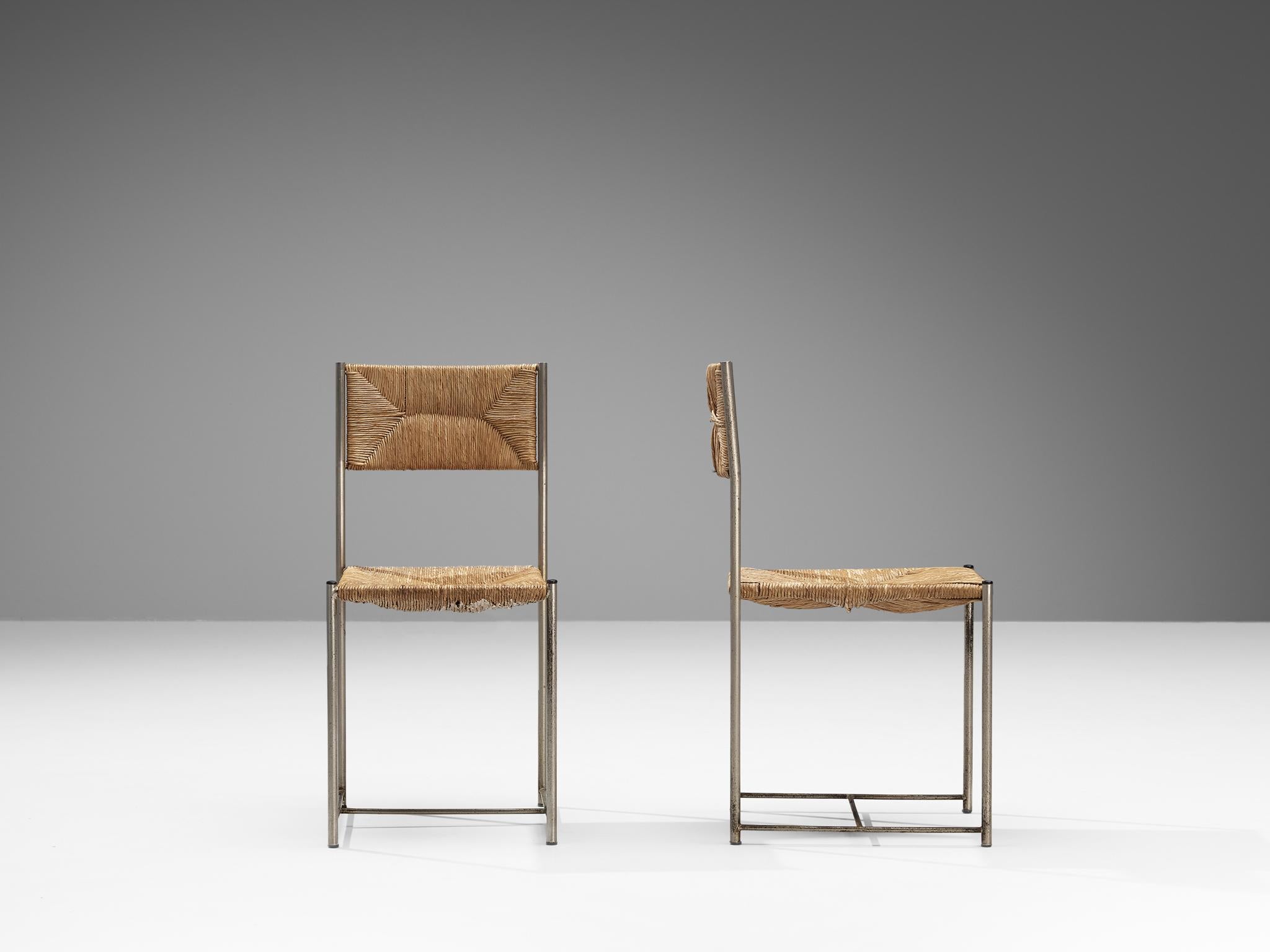 Dining room chairs, patinated steel and straw, Italy, 1970s

A beautiful pair of chairs made in Italy in the 1970s. These chairs are characterized by clear lines and the use of metal in combination with natural material for the seats and