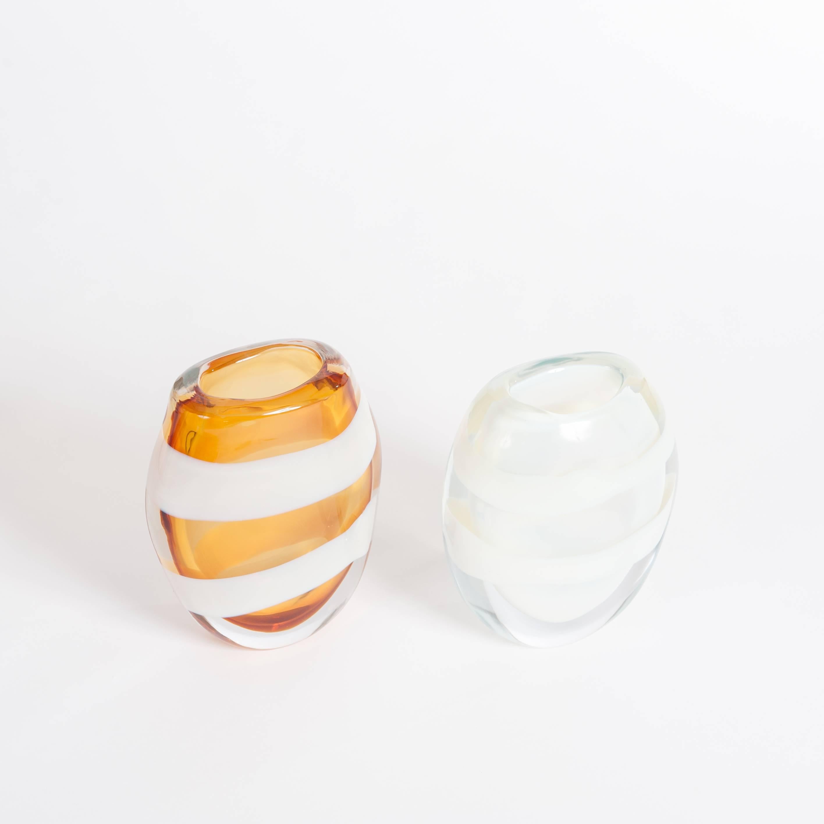 Modern Italian pair of heavy cognac and opalescent colored Murano glass vases signed by Pino Signoretto.
Transparent glass objects made out of thick glass layers (total 2.5cm) shaped like eggs made in Sommerso Technique 
with two white circular