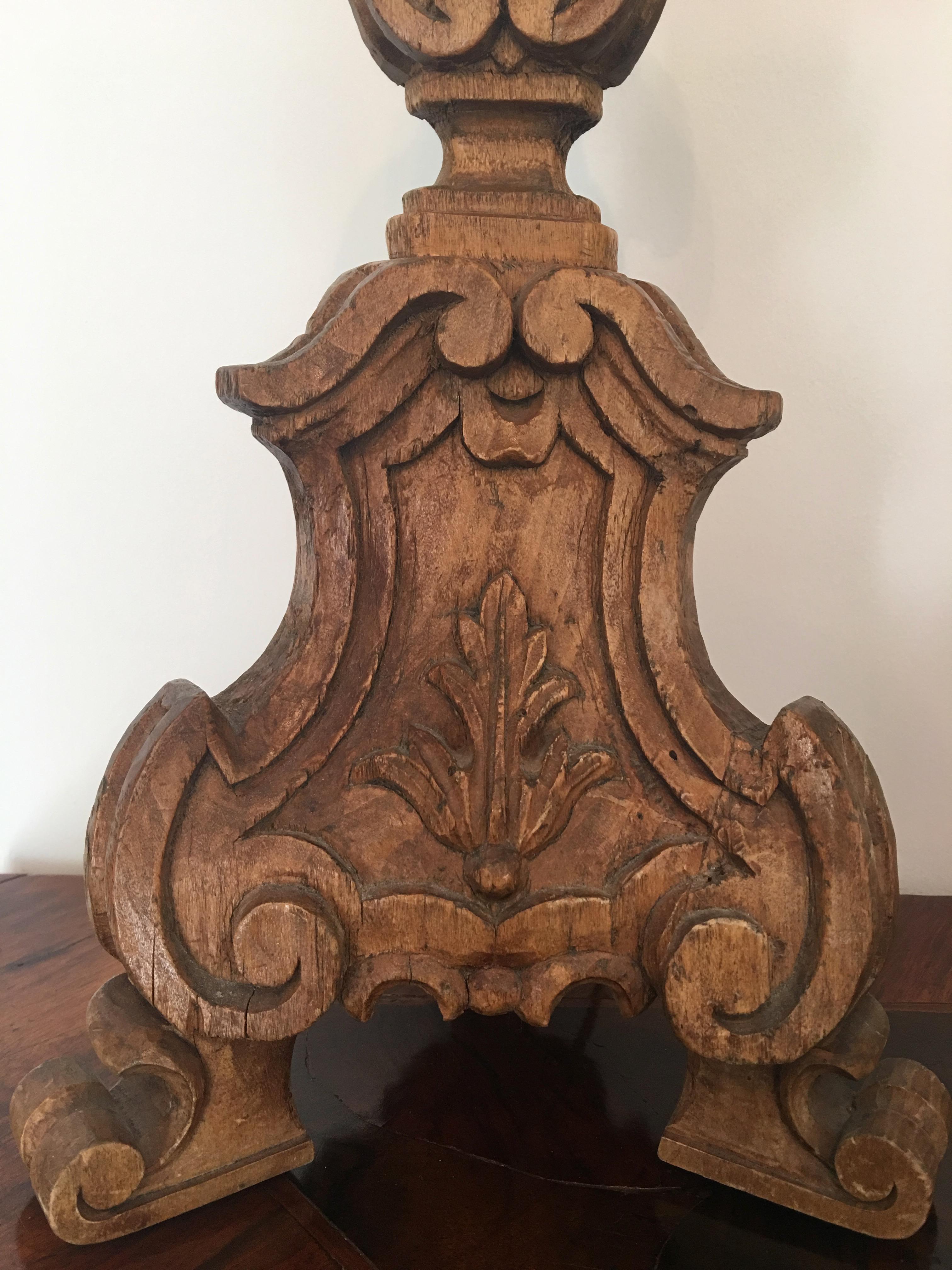 Italian pair of large walnut carved with a leaf motif candlesticks, early 19th century.
    