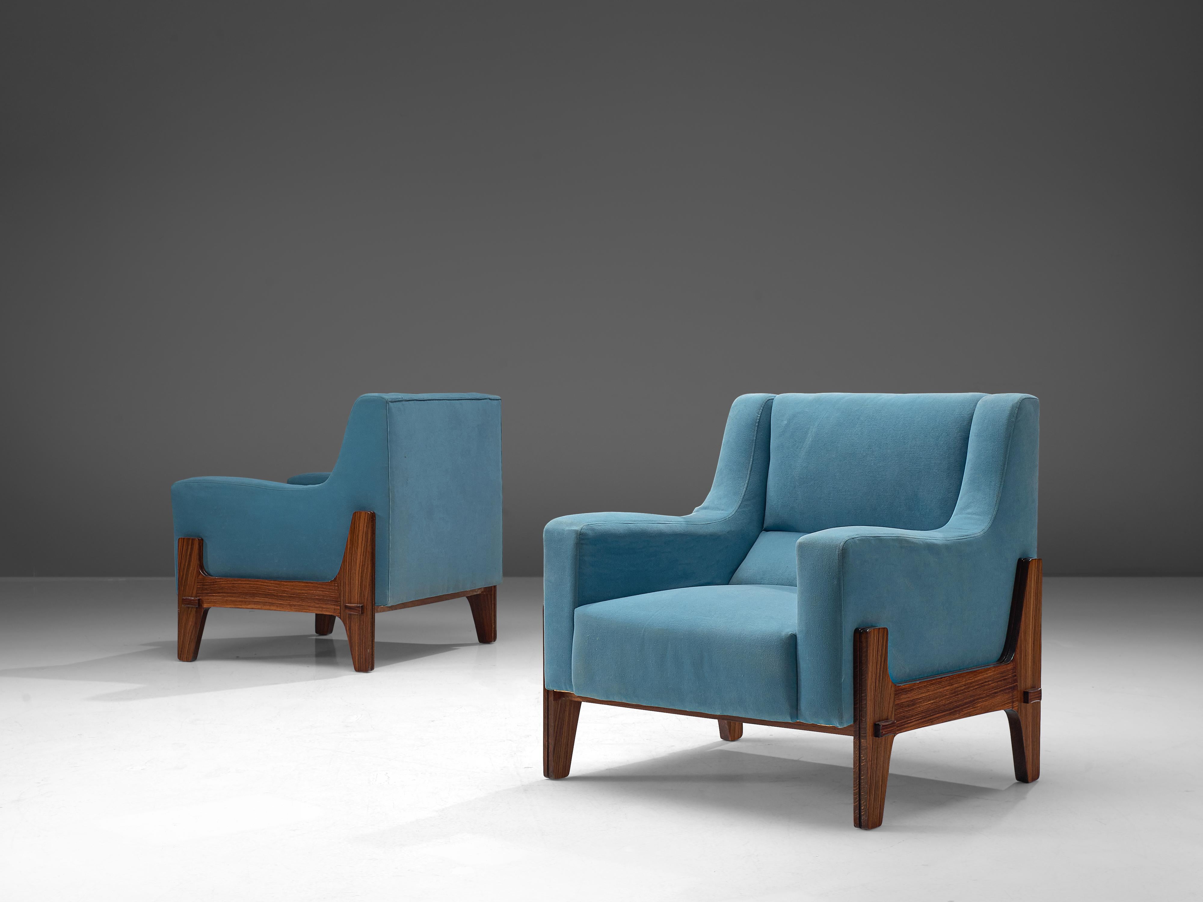 Eugenia & Luigi Reggio, set of two lounge chairs, rosewood, bright blue fabric, Italy, 1950s.

This Italian pair of lounge chairs from the 1950s features a sturdy frame made of rosewood that is beautifully exposed on the outside of the seat and