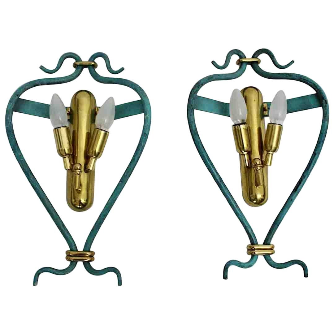 An Italian pair of Mid-Century Modern vintage blue sconces with brass details, which was handmade, 1960s.
Each sconce has two E 14 sockets and is edged with a blue lacquered iron frame in a charming shape.
Good condition with signs of age and use
