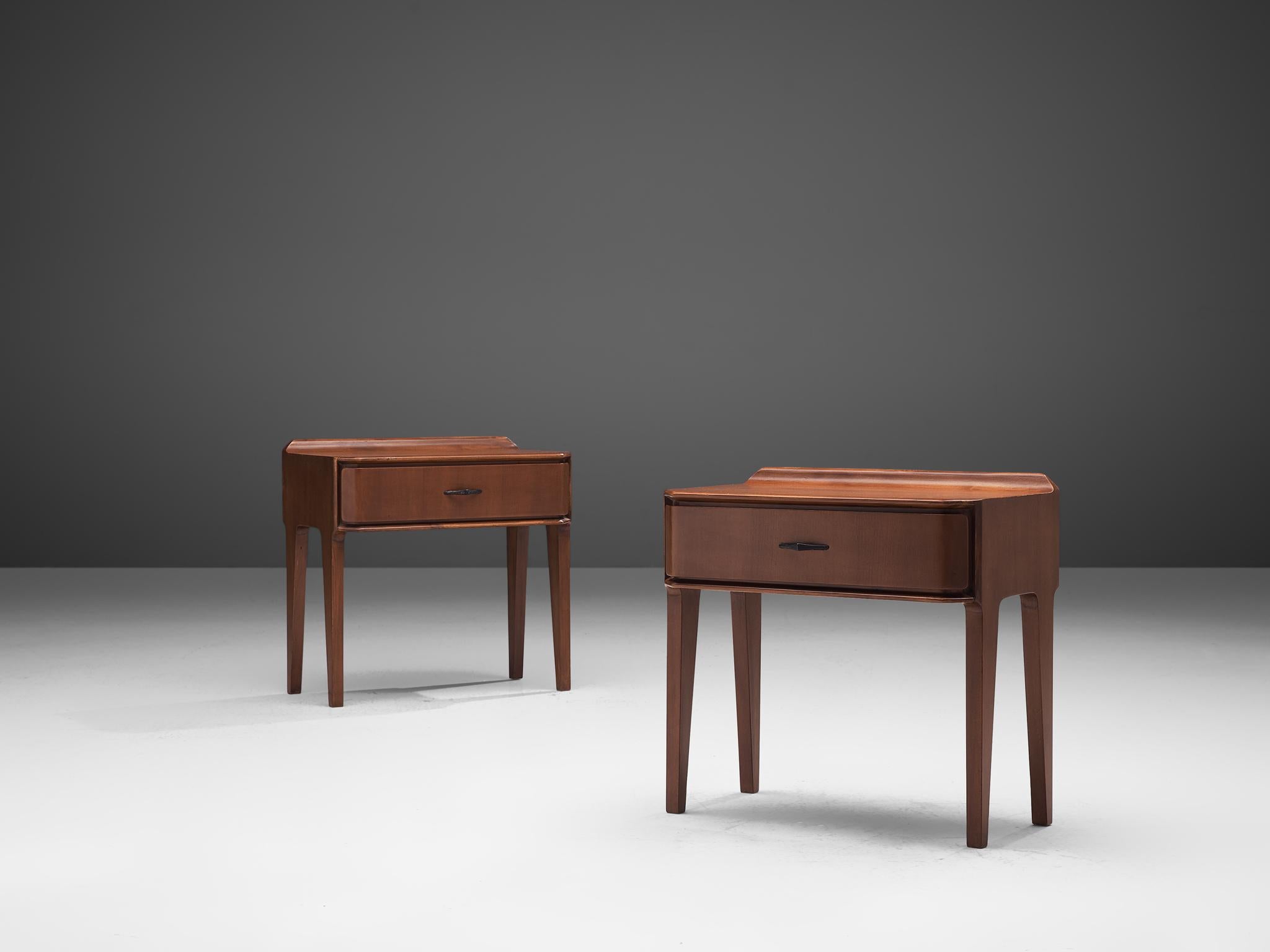 Pair of nightstands, walnut, Italy, 1960s

These two side tables or nightstands are both refined and simplistic. Each piece is equipped with a drawer for storage. The top is rectangular shaped with beveled corners, that run through the drawers as