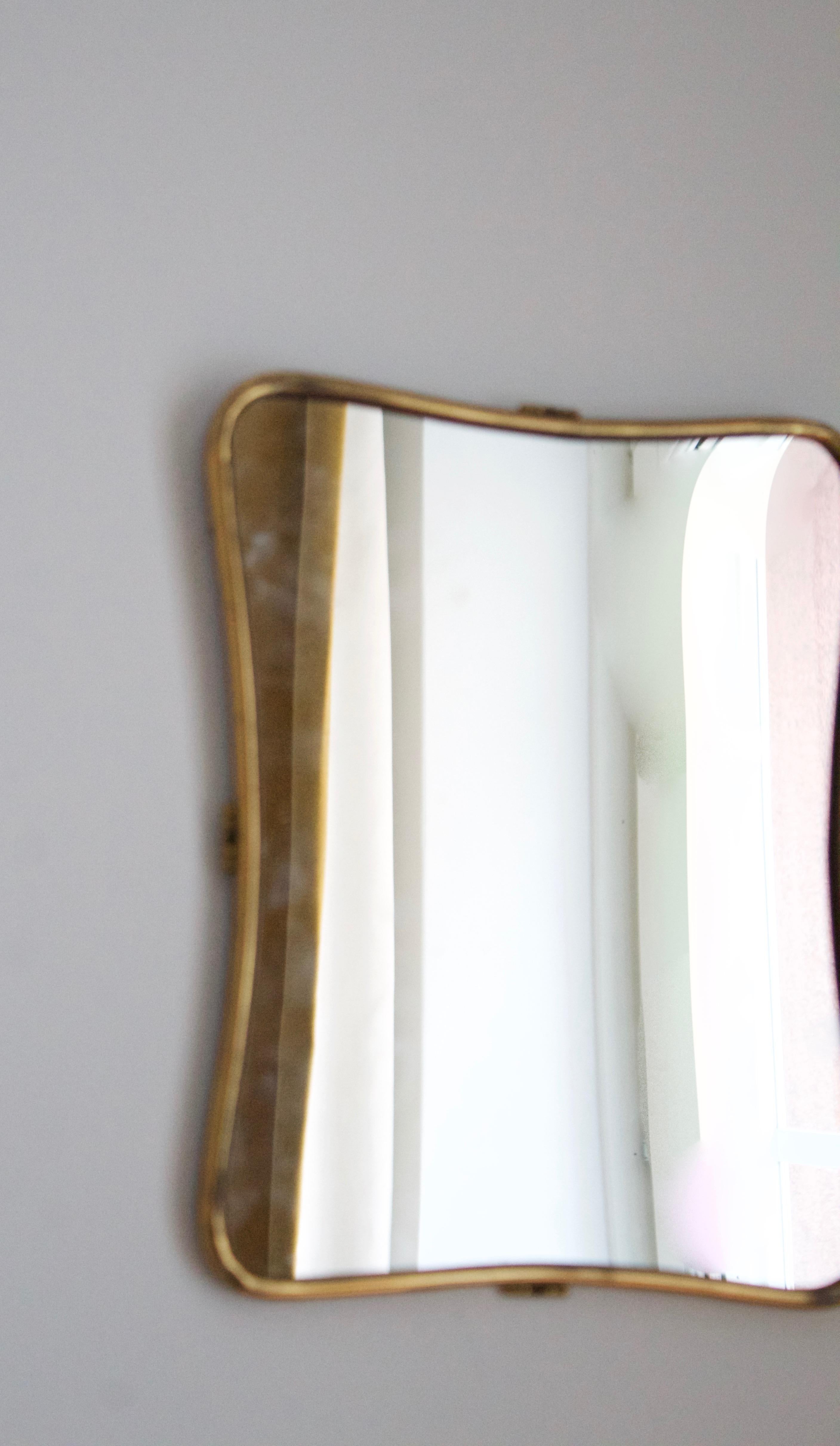 An organic wall mirror, produced in Italy, 1940s-1950s. Organically cut mirror glass is framed in brass.

Other designers of the period include Gio Ponti, Fontana Arte, Max Ingrand, Franco Albini, and Josef Frank.