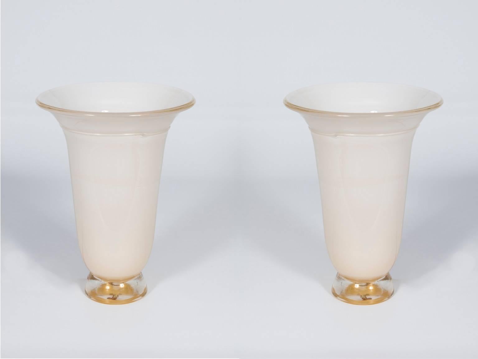 Italian Venetian, pair of table lamps, in blown murrain glass, white and gold,  1980s.
This is a unique set, of handcrafted blown Murano glass table lamps, in a shape of a vase, white milk color submersed in a gold thin layer of gold, that provides
