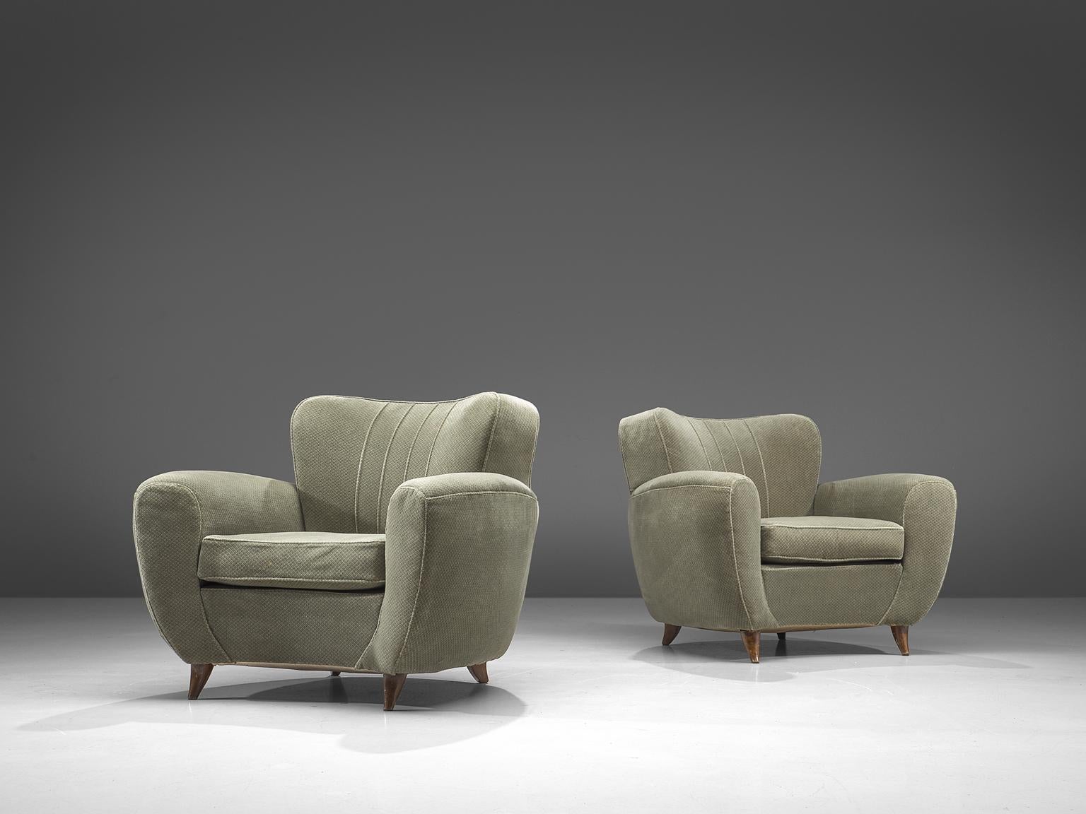Set of lounge chairs, green fabric and wood, Italy, 1950s.

Wide and comfortable chairs in a pastel green patterned fabric upholstery. A wonderful set of lounge chairs that feature a deep seat and rounded, curved armrests. The backrest is voluptuous