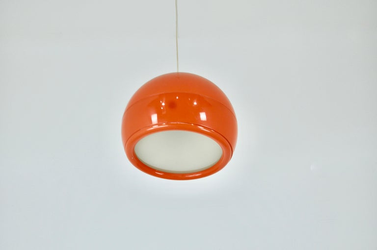 Plastic chandelier in orange color. Wear due to time and age of the lamp.