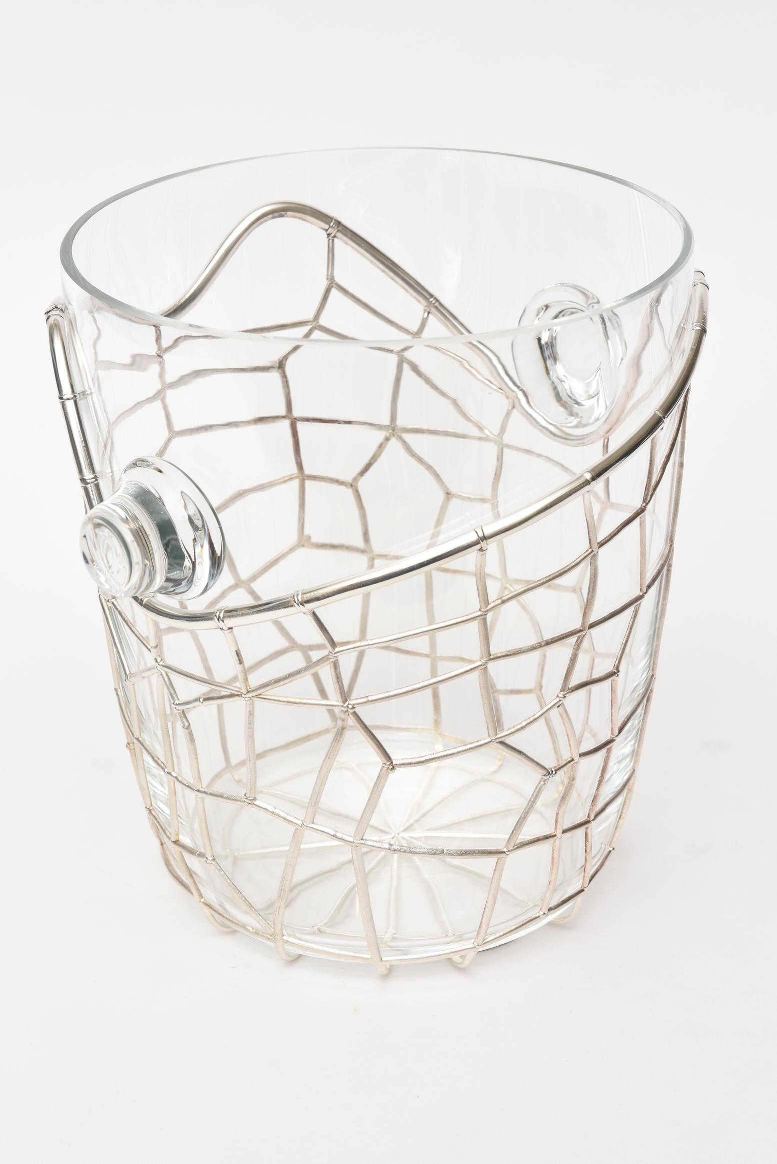 This absolutely stunning and sculptural signed Italian Pampaloni sterling silver and glass ice and champagne bucket is vintage. It is like a web of sterling silver abstract form on the outside with a glass insert with glass handles. This was never