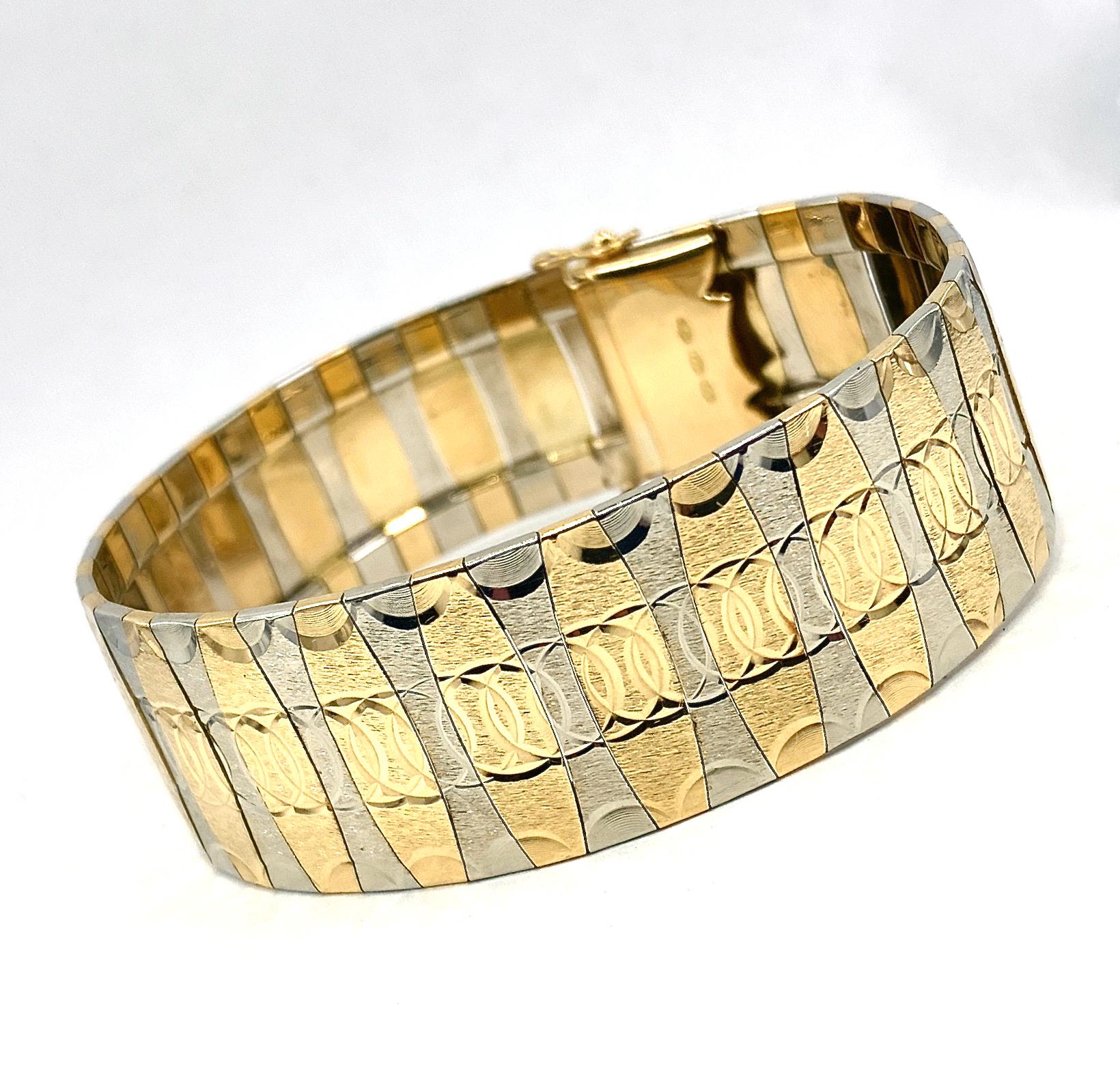 This beautifully made Italian bracelet features 18 karat yellow and white gold panels with a continuous diamond-cut pattern of interlocking circles.  The circle motif continues along the  scalloped, high-polish edges.  

CLOSURE:  A tidy box clasp