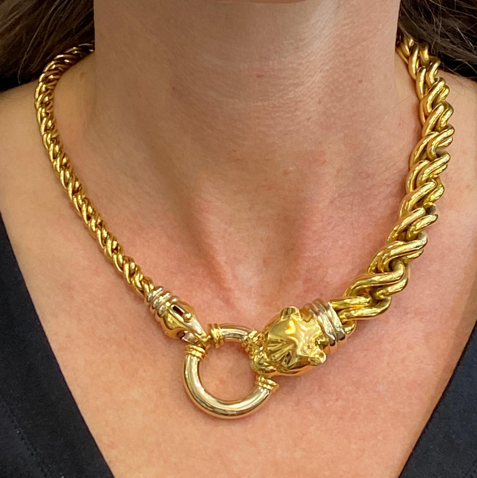 Stylish Italian panther head link necklace fashioned in 18 karat  yellow gold. The graduated twist links measure 6.6-14.5mm in width. The panther head measures .80 x 1.25 inches, and the necklace measures 17 inches in length. Hallmarked with a sun