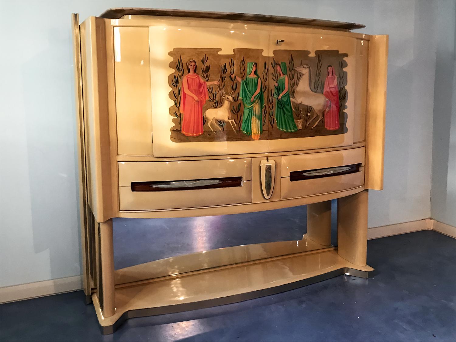 This bar cabinet is in very good conditions of the period as the images show, and is one of the masterpieces of Vittorio Dassi.
It's entirely finished in parchment and enriched frontally by a painting in the style typical of 20th century Italian