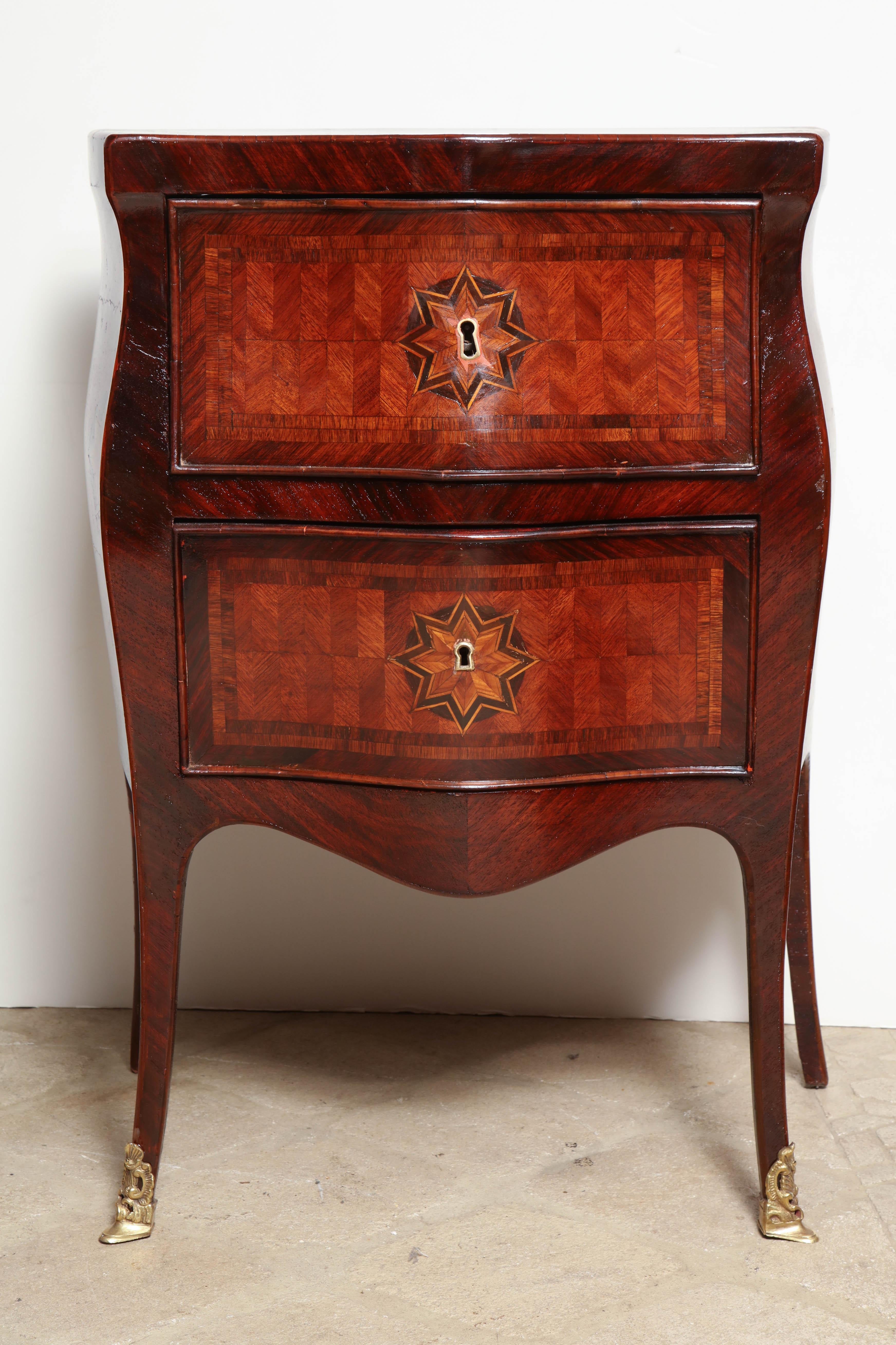 Italian Louis XV parquetry inlaid two-drawer petit commode of Bombay form with serpentine front and side and bronze sabots.