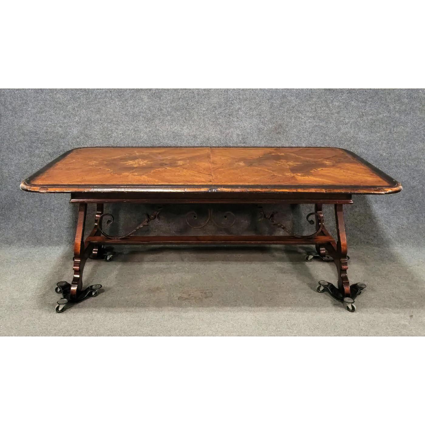 Italian parquetry walnut extension dining table with an inlaid parquetry pattern top, with molded edges and a hand-rubbed antiqued patina above trestle end supports with hand forged iron scrollwork and a stretcher. 20th century.

Dimensions: