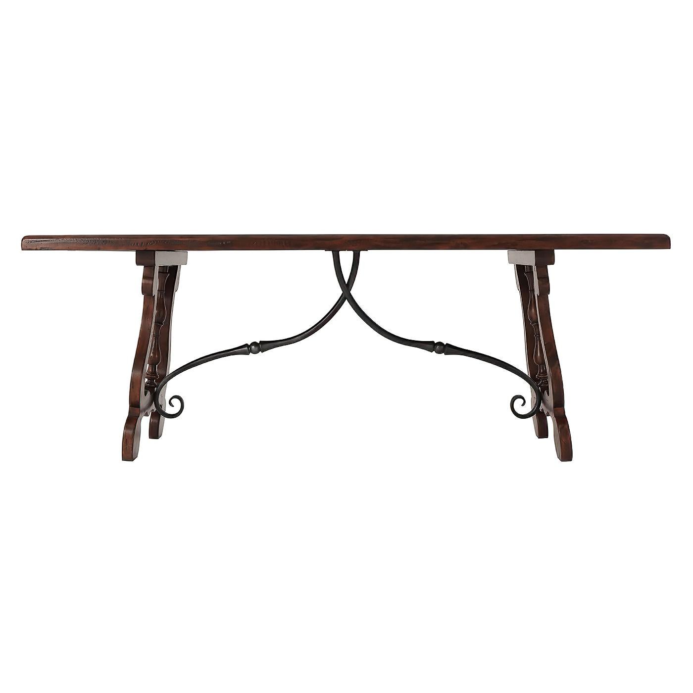 A 17th century Italian style antiqued wood refectory dining table or kitchen table, the top with stellar parquetry above splayed lyre ends joined by wrought iron stretchers.
Dimensions: 82
