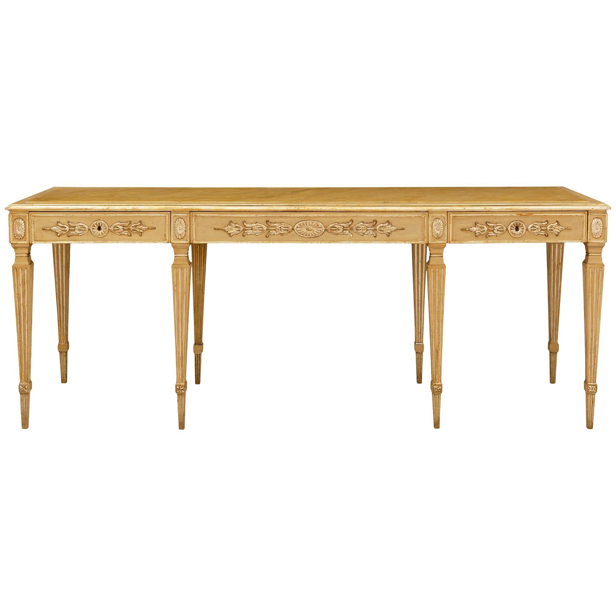 An elegant and most decorative Italian Turn of the Century patinated wood, faux painted marble, and Silvered Mecca center table. This wonderful rectangular table is raised on eight square, tapered, and fluted legs with block reserves accented with
