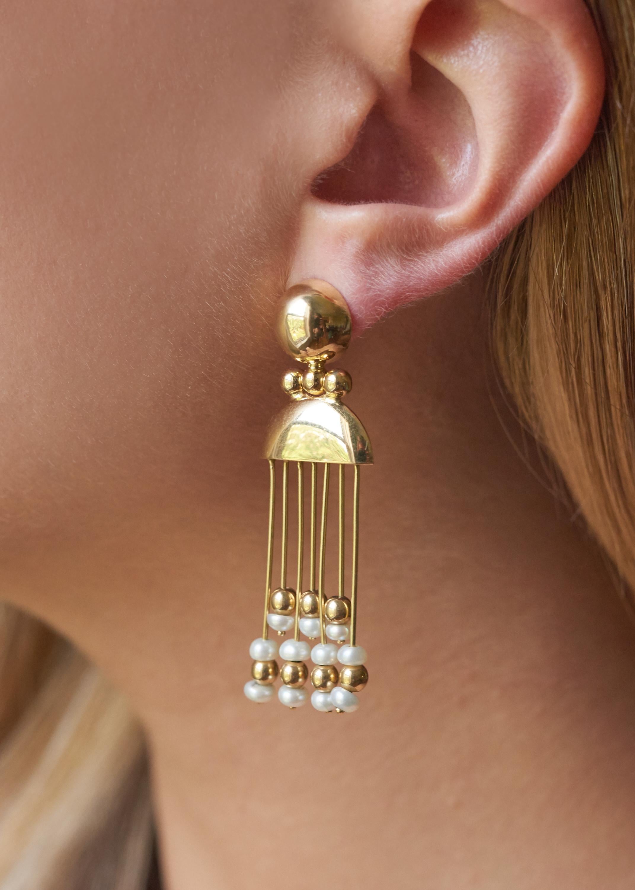 A pair of Italian pearl and 18 karat gold fringe earrings.
The earrings are stamped 750 and Italian Registered Trademark Number 805 VI, for Vicenza manufacture. 
Post packs for pierced ears. 
These are a romantic pair of good length that work