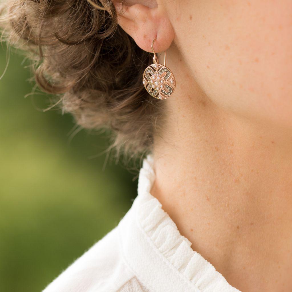 For pierced ears.
Silver and rose gold earrings. 
Lever- back earrings, they are set with crystals and small white glass pearls on a round openwork design.
The clasp is a swan neck with safety hook.
Height : 2,8 cm, width : 1,7 cm
Weight : 4,4 g
