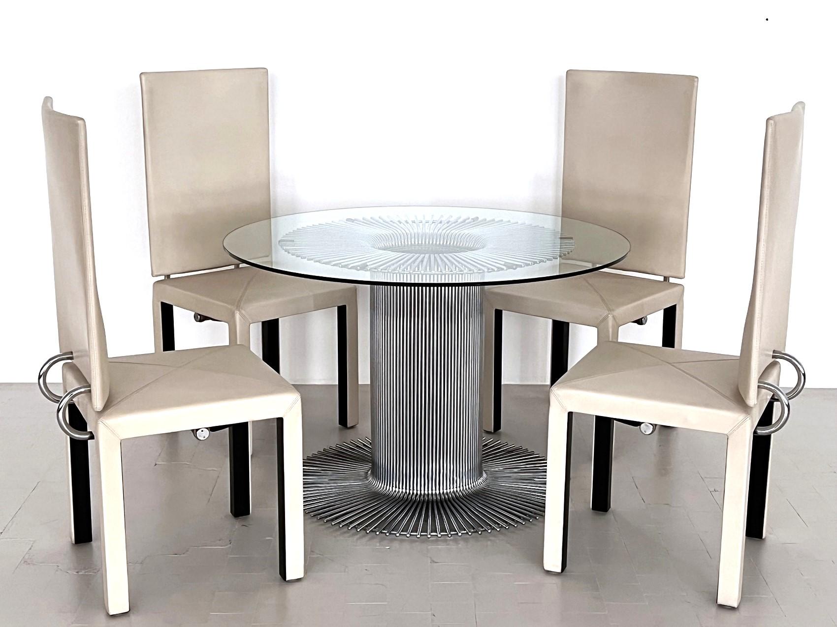 Beautiful round dining table made of chromed metal with glass top
Made in Italy,  ca. 1960s

Pedestal dining table with a sculptural tubular chrome base and clear glass top. 
Designed and Made in Italy. 
Particular design of the central base, with a