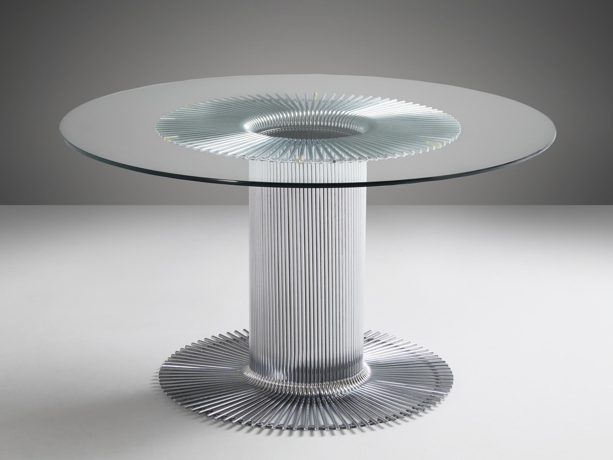 Round dining table, chromed metal, glass, Italy, 1960s 

Pedestal dining table with a sculptural tubular chrome base and clear glass top. Designed in Italy. Distinguished design of the central base, with a beautiful visual effect due to the