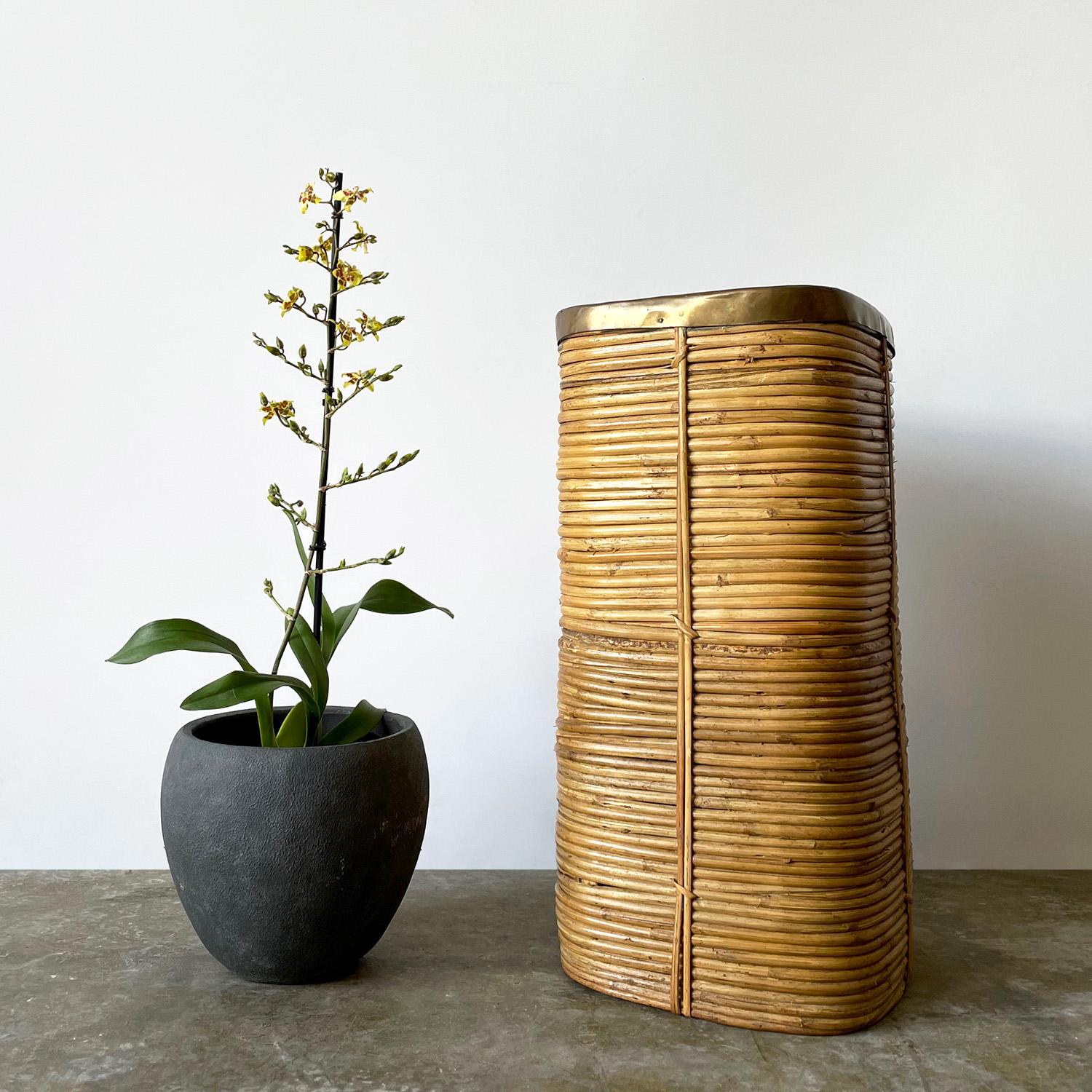 Italian pencil reed bamboo planter bin in the style of Gabriella Crespi
Coiled bamboo vessel with natural color variations
Aged brass rim 
Substantial piece in weight and composition
Patina from age and use
Can be used as a waste bin, umbrella