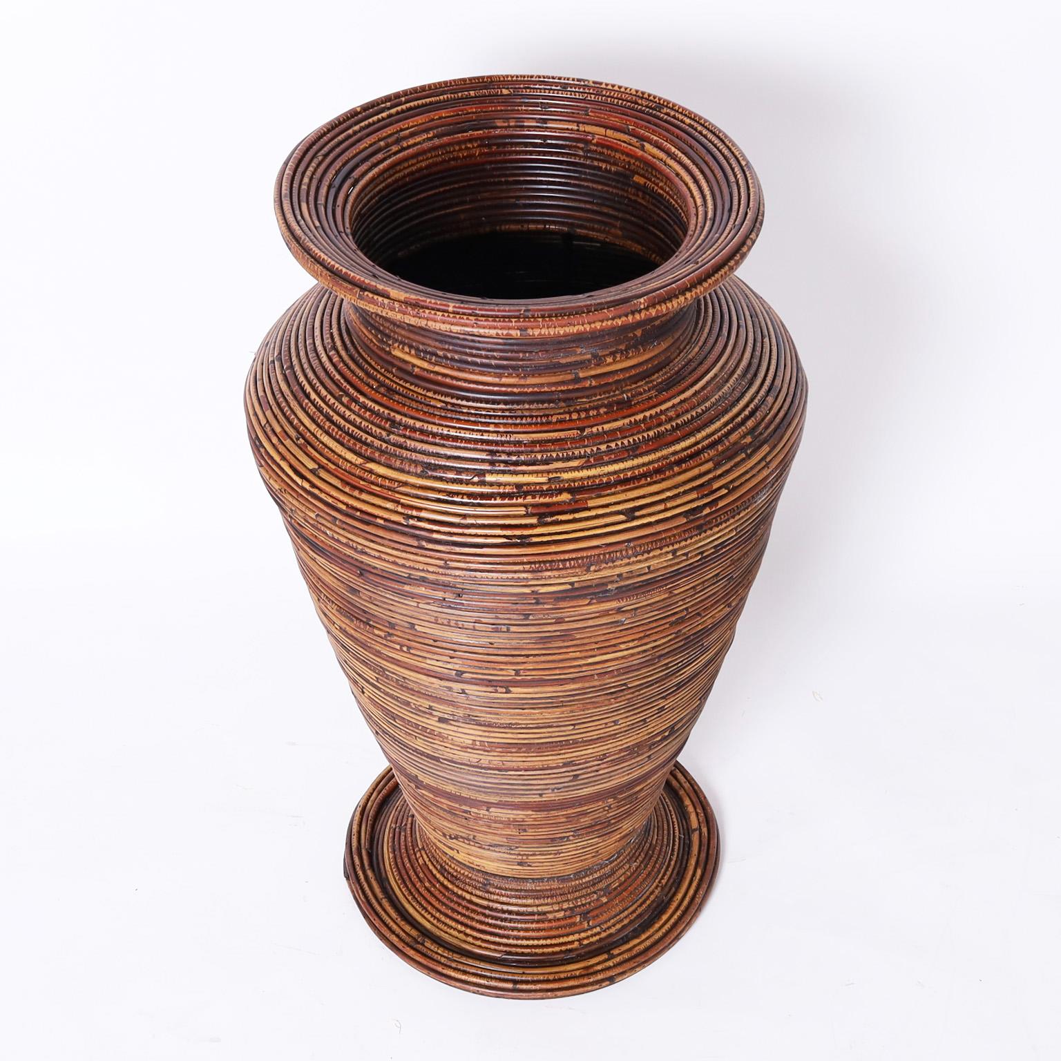 Large and impressive mid-century urn crafted in pencil reed in a classic modern form with a lush variegated brown finish.