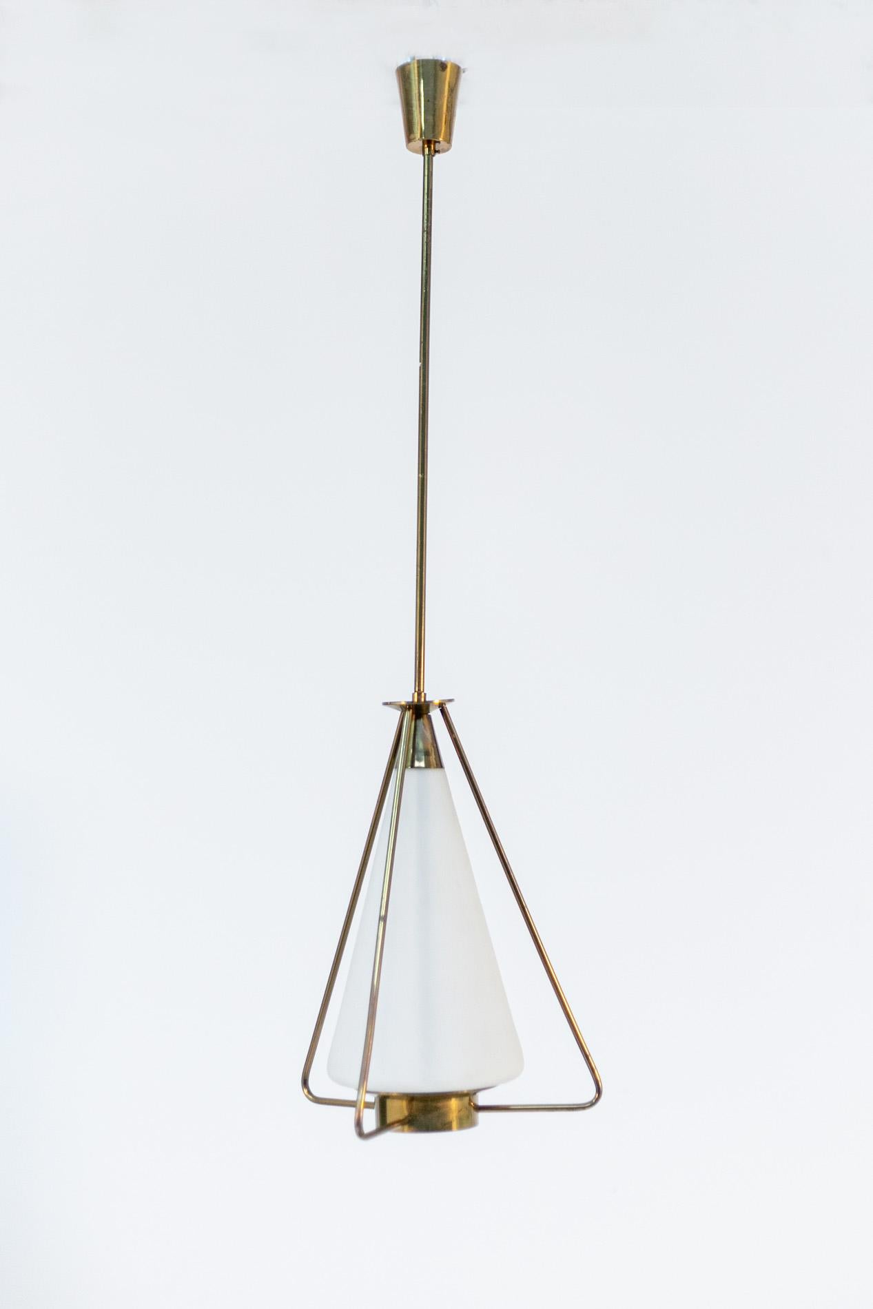 Elegant Italian pendant of 1950s stilnovo manufacture. The pendant is made with a brass frame. Radiating from the main stem at the bottom are three brass tubes that serve as both ornamentation and support. The light holder is made of opal glass with
