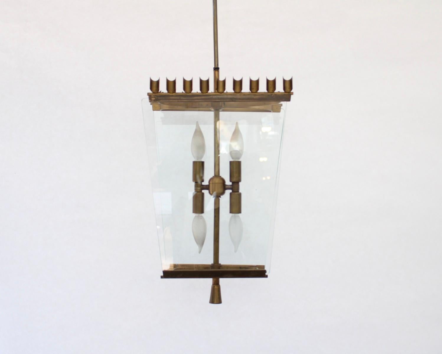 Italian decorative c 1940's pendant chandelier attributed to Fontana Arte. Decorative bronze frame with scalloped crown motif at the top and tapering glass panels. 
Glass is held in place at both top and bottom by a bronze frame. 
Terminating in a