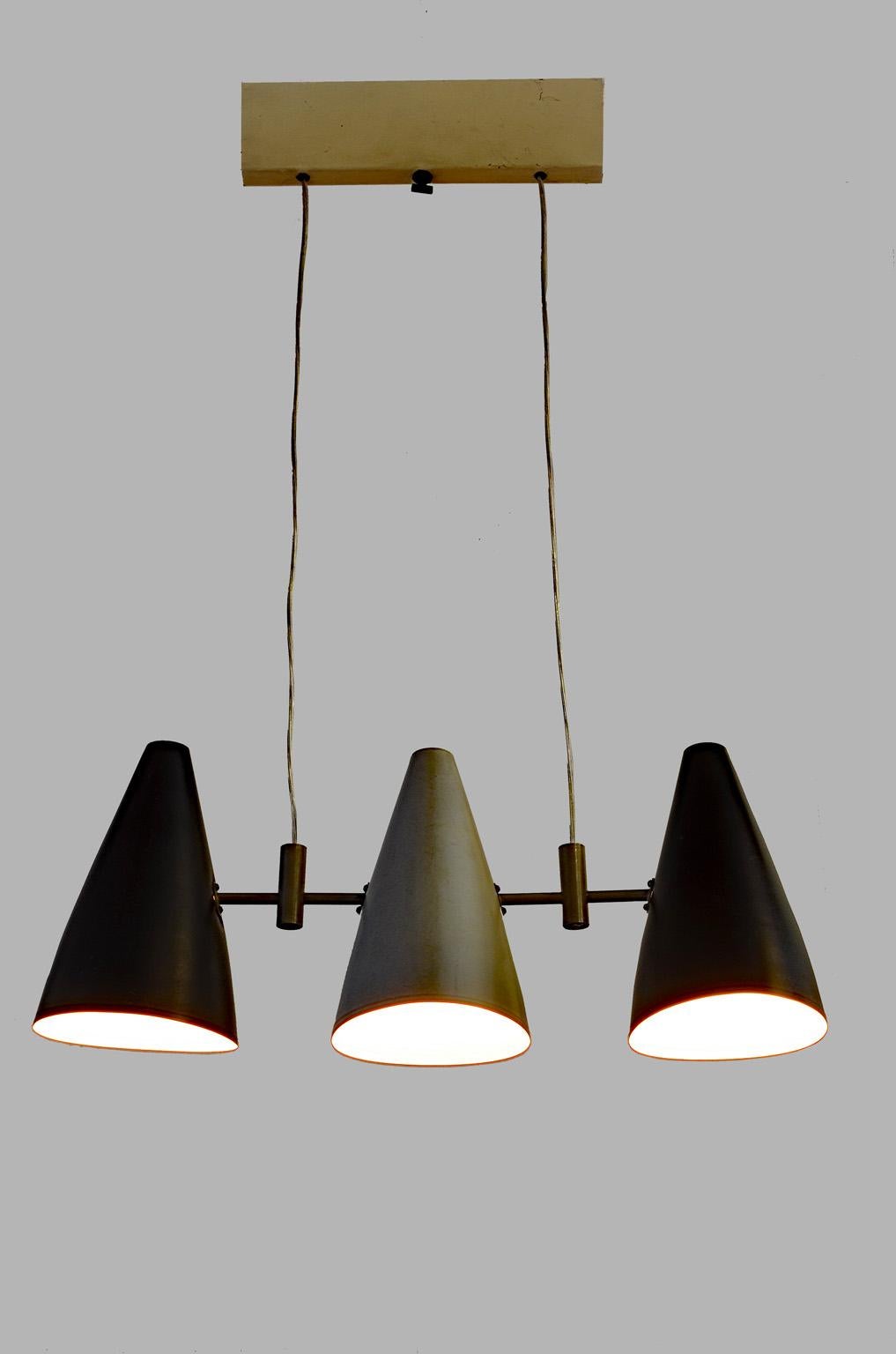 This Italian pendant lamp was manufactured in the 1950s. It is made from metal and features three lamp shades lacquered in black and gray.
