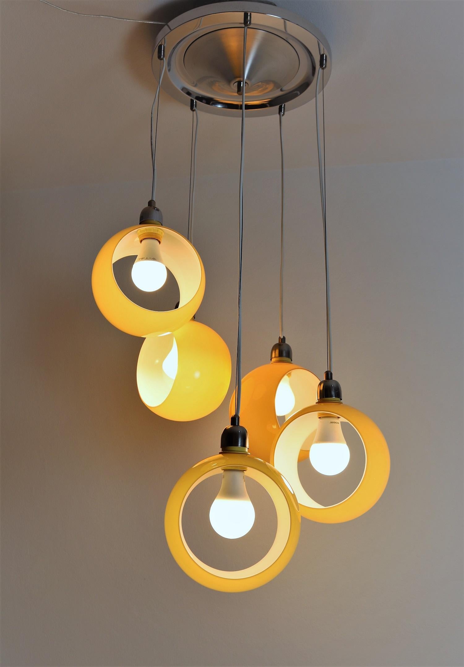 Gorgeous and rare cascade pendant lamp with five beautiful shiny and submerged Murano glasses (inside white, outside yellow), which can be turned in a desired position.
Designed n the style of Carlo Nason, manufactured from Mazzega in the