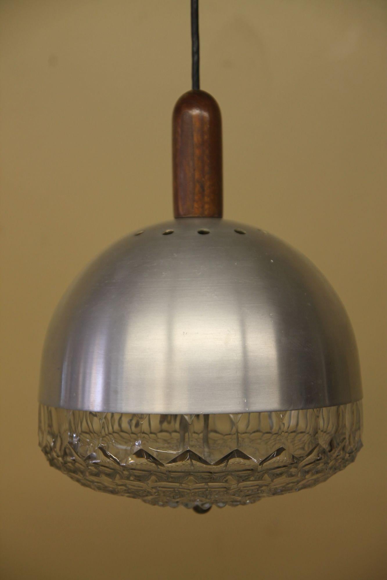 Pleased to offer this great Italian pendant lamp. This light has a beautiful glass bottom with a aluminum top. There is a wood accent piece on top of the light and then the cord extends to a aluminum cap. Cord can shortened or lengthened if needed.