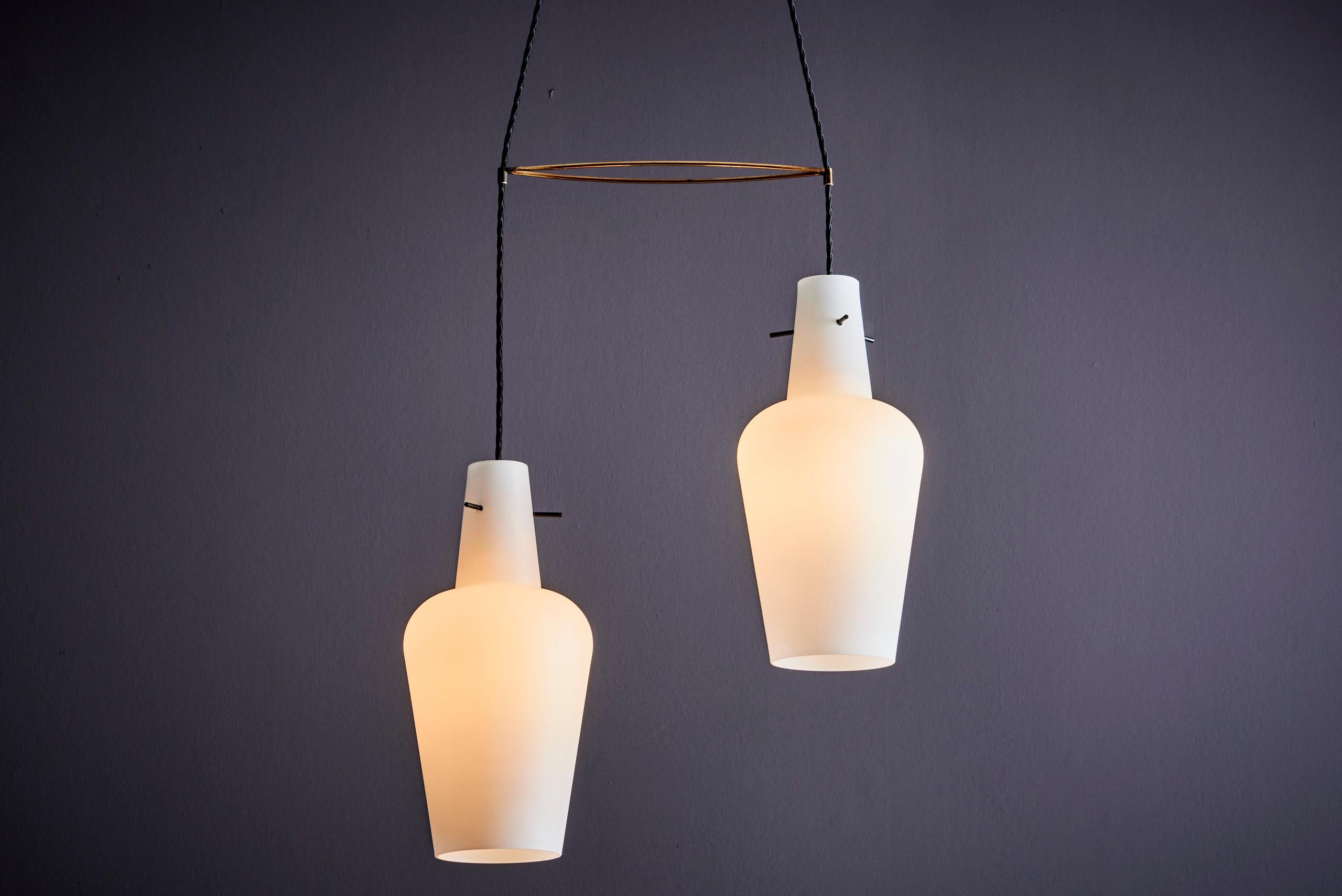 Interesting Italian Pendant Light with two glass shades. With the unique brass element one can adjust the lights at will. Wonderful for a staircase. The measurements given apply to the measurements of one shade.

Please note: Lamp should be fitted