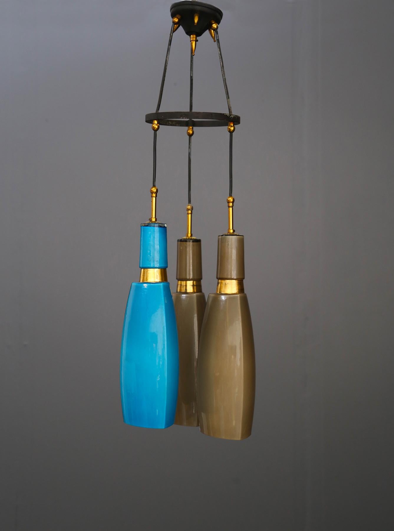 1950s pendant by Vistosi in colored opaline glass. The pendant has 3 lights. The structure that supports the lamp holders is made of painted iron with ornamental elements in chrome-plated brass. The various connecting elements are also in brass. The
