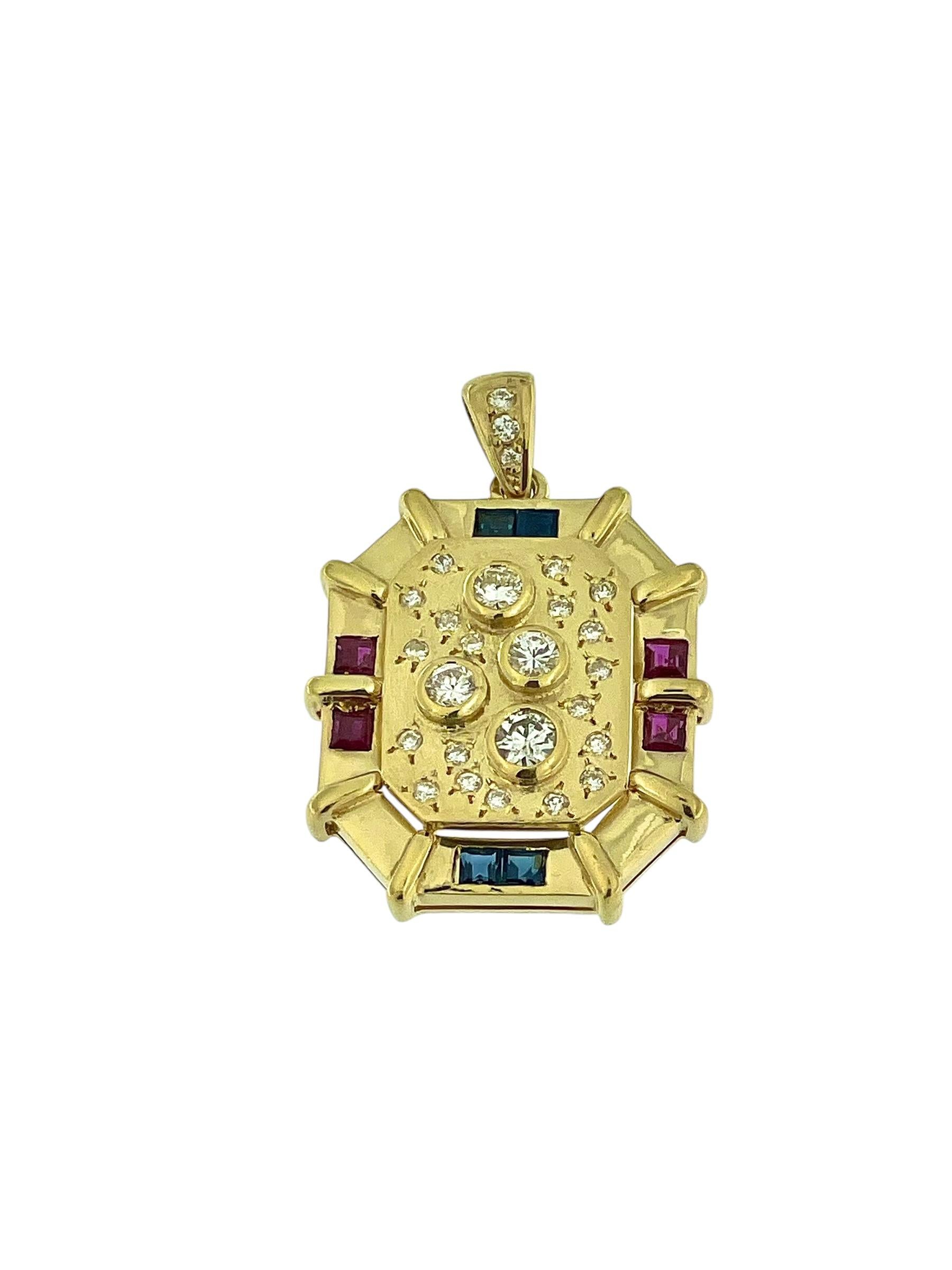 This Italian Pendant is a stunning showcase of vibrant gemstones and exquisite craftsmanship, crafted in 18kt yellow gold. The design features a luxurious combination of diamonds, rubies, and sapphires, arranged in a timeless and elegant