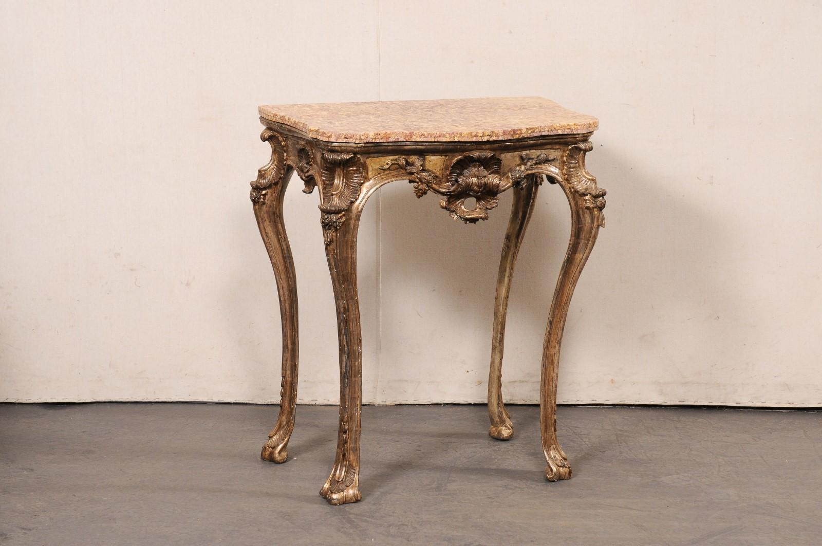 An Italian Rococo smaller-sized carved-wood table, with its original finish and a marble top, from the 18th century. This antique side table from Italy has a beautiful marble top with curvy serpentine front, canted and bowed side corners, and