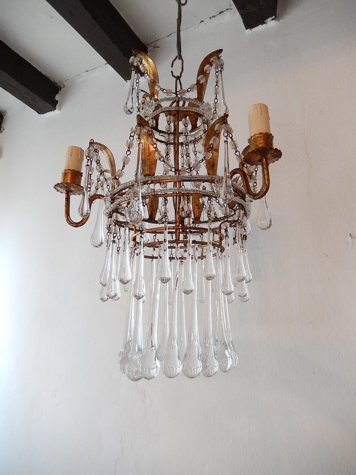 Housing 3 lights. Gilt metal body with tiny beading and florets. Gilt metal with swags of macaroni beads and many clear Murano drops. Original chain and canopy. Will be newly rewired with certified US UL sockets for the Usa and appropriate sockets