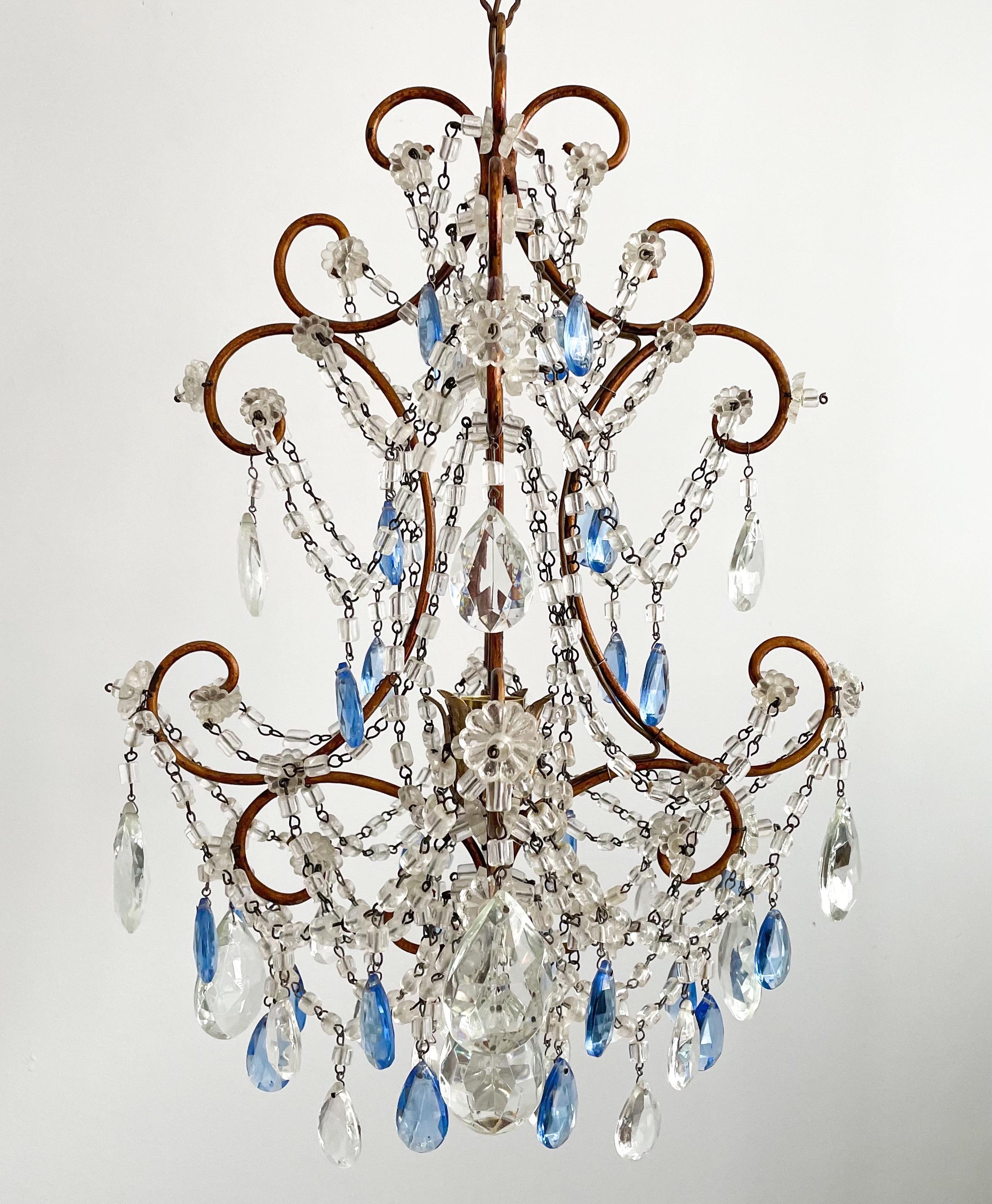 Beautiful, 1950s Italian gilt-iron crystal beaded chandelier.
 This small-scale chandelier consists of a scrolled, gilded iron frame which has been decorated with an abundance of “macaroni” glass beads and faceted prisms in clear and royal blue