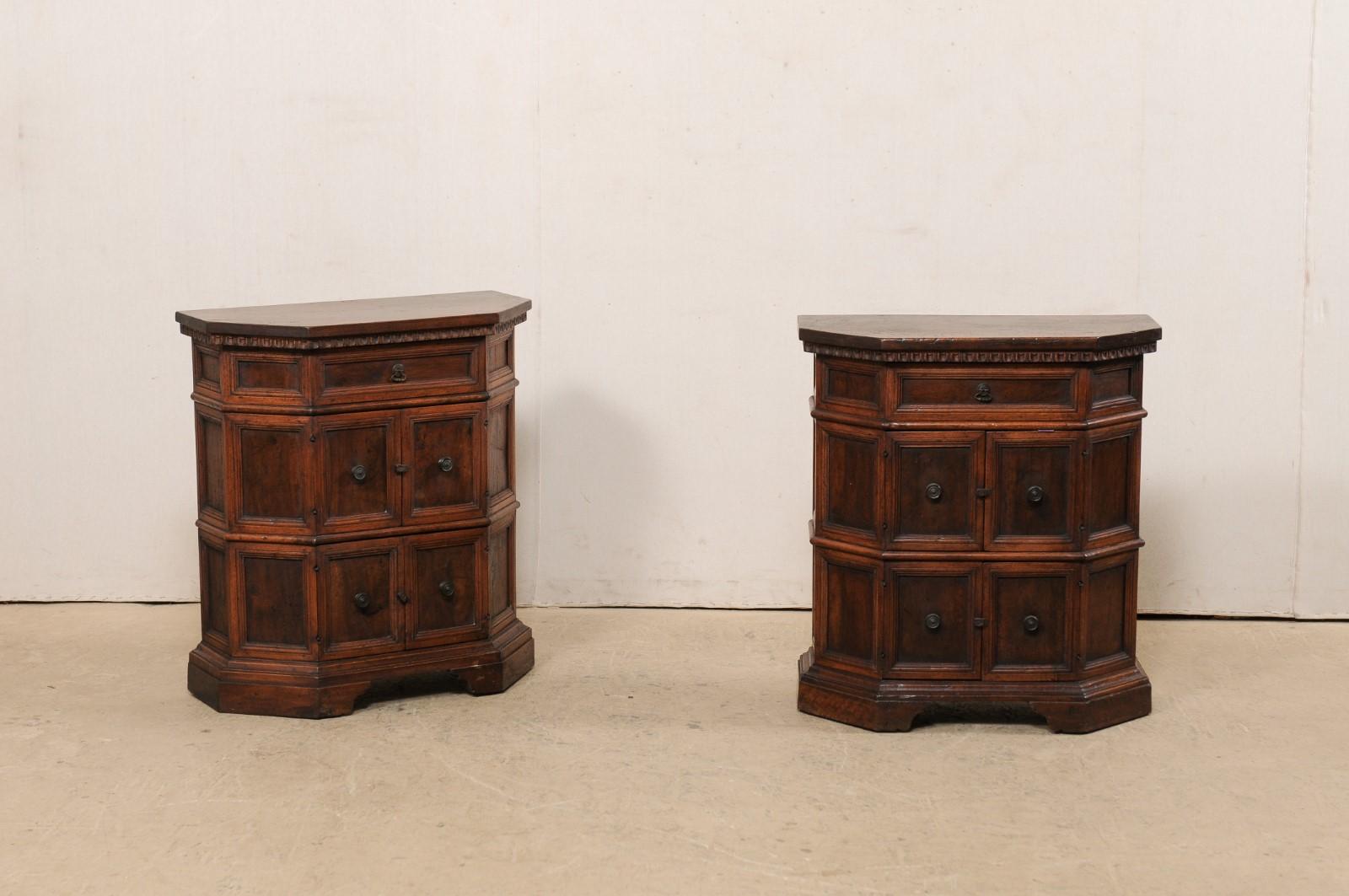 An Italian pair of petite sized console cabinets from the early 19th century. This antique pair of chests from Italy each have beautifully molded and recessed panels adorning their bodies, with egg-n-dart carved trim beneath the top with it's