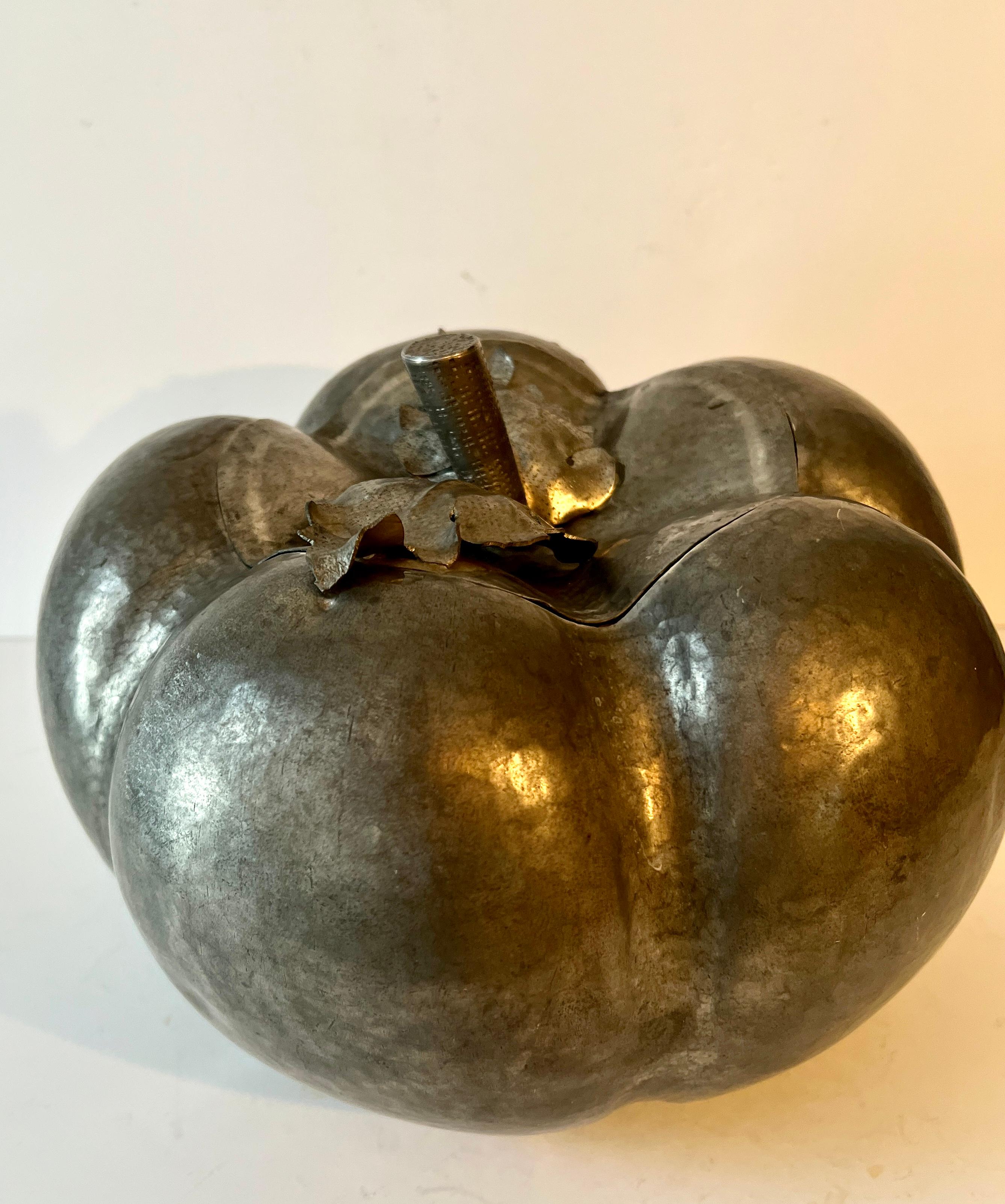 A very large Pewter Pumpkin designed to be an ice bucket.  A lid holds the stem and leaves of the pumpkin.  The large round and segmented shape, very much resemble a pumpkin or Gourd.

The Piece does make a large size for Ice, however, it could also