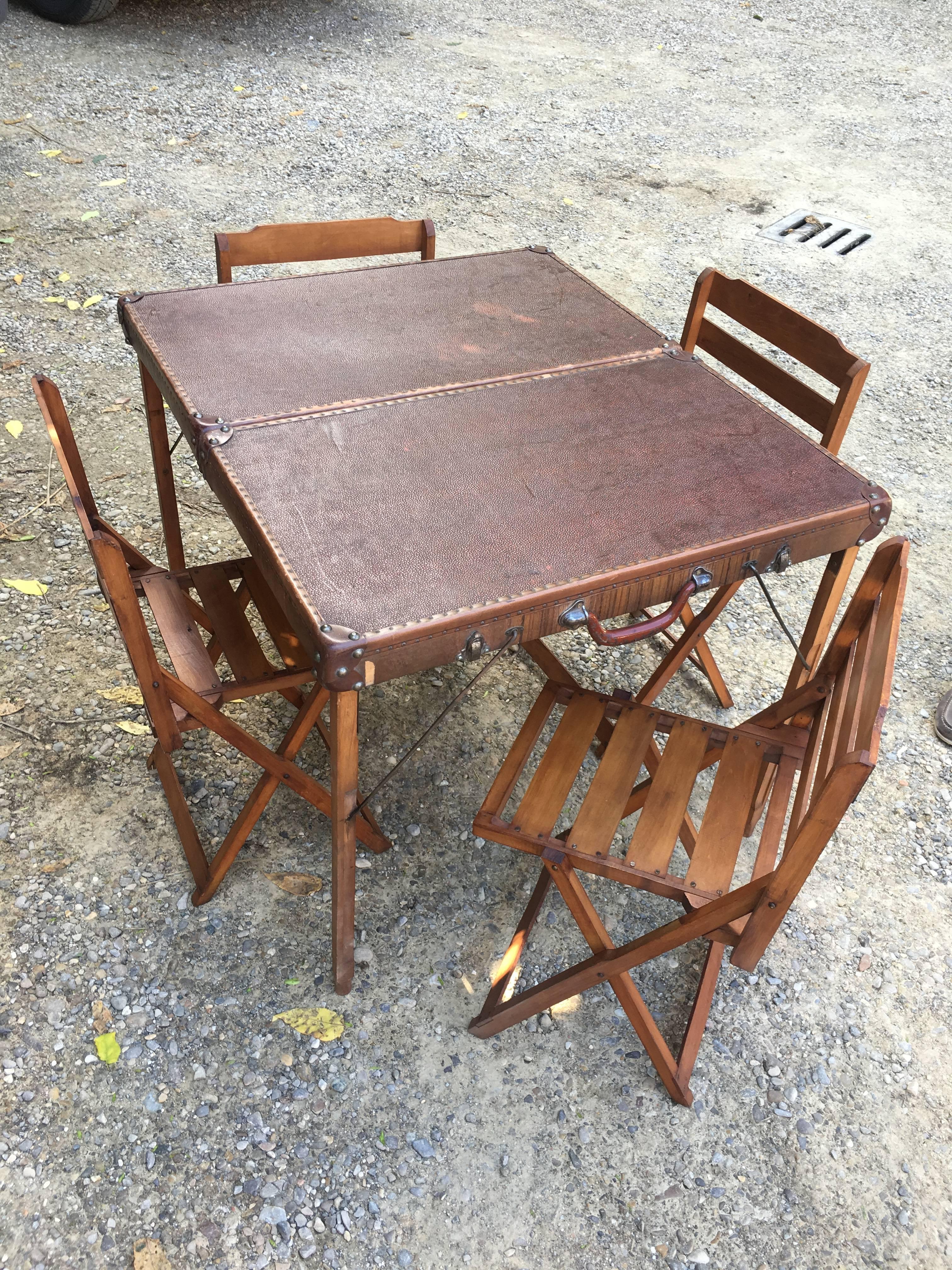 Italian picnic folding table with chairs from 1950s
When closed, the table becomes a baggage and contains the four chairs.
Measurements:
Table when opened: cm.85 x 75 x H 70
Table when closed: cm.43 x 74 x H 14.
 