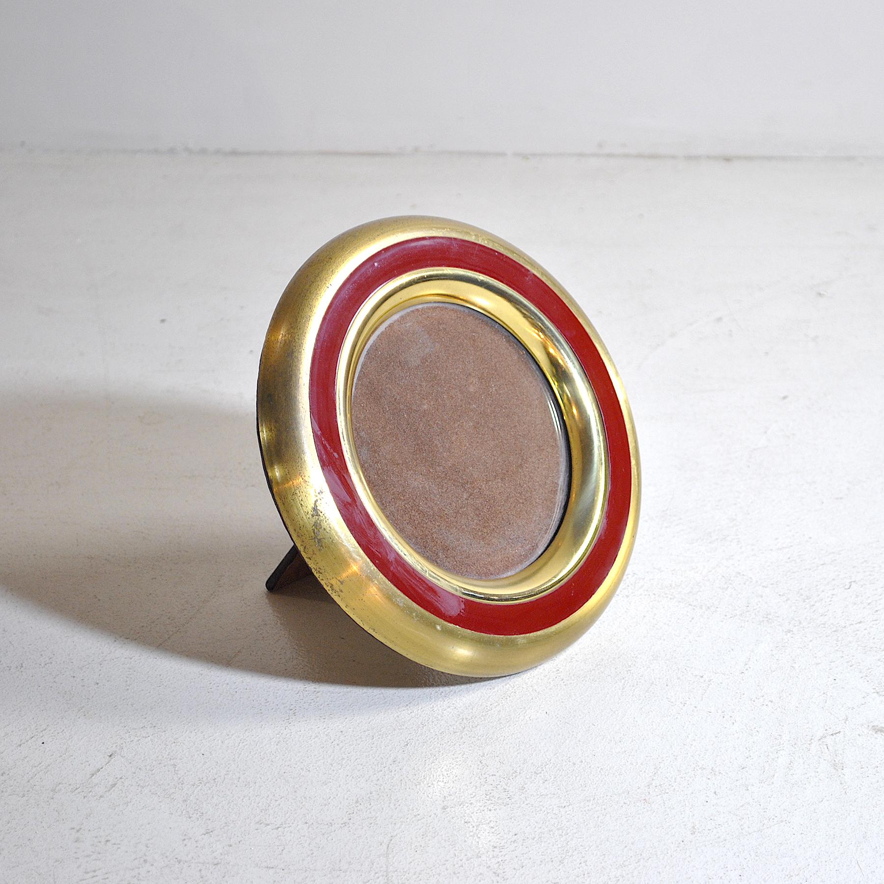 A picture frame in brass and a circle in lacquered metal.