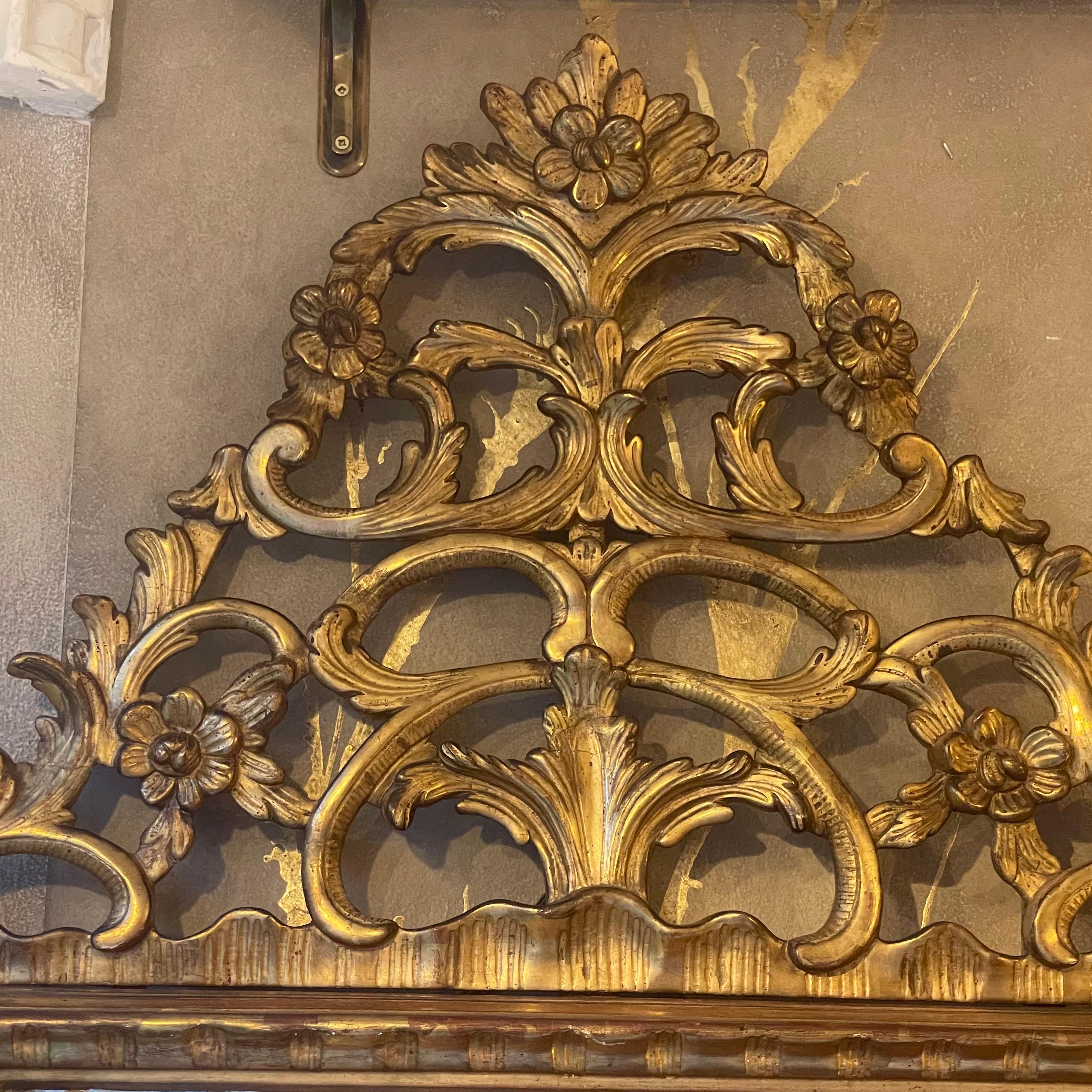 A large, highly carved Piedmontese giltwood mirror, topped with a pierced foliate crest. The scrolling leaves continue down either side, repeating at the top of each scrolled paw foot.
This Italian 1780s mirror with original plate, and sectional