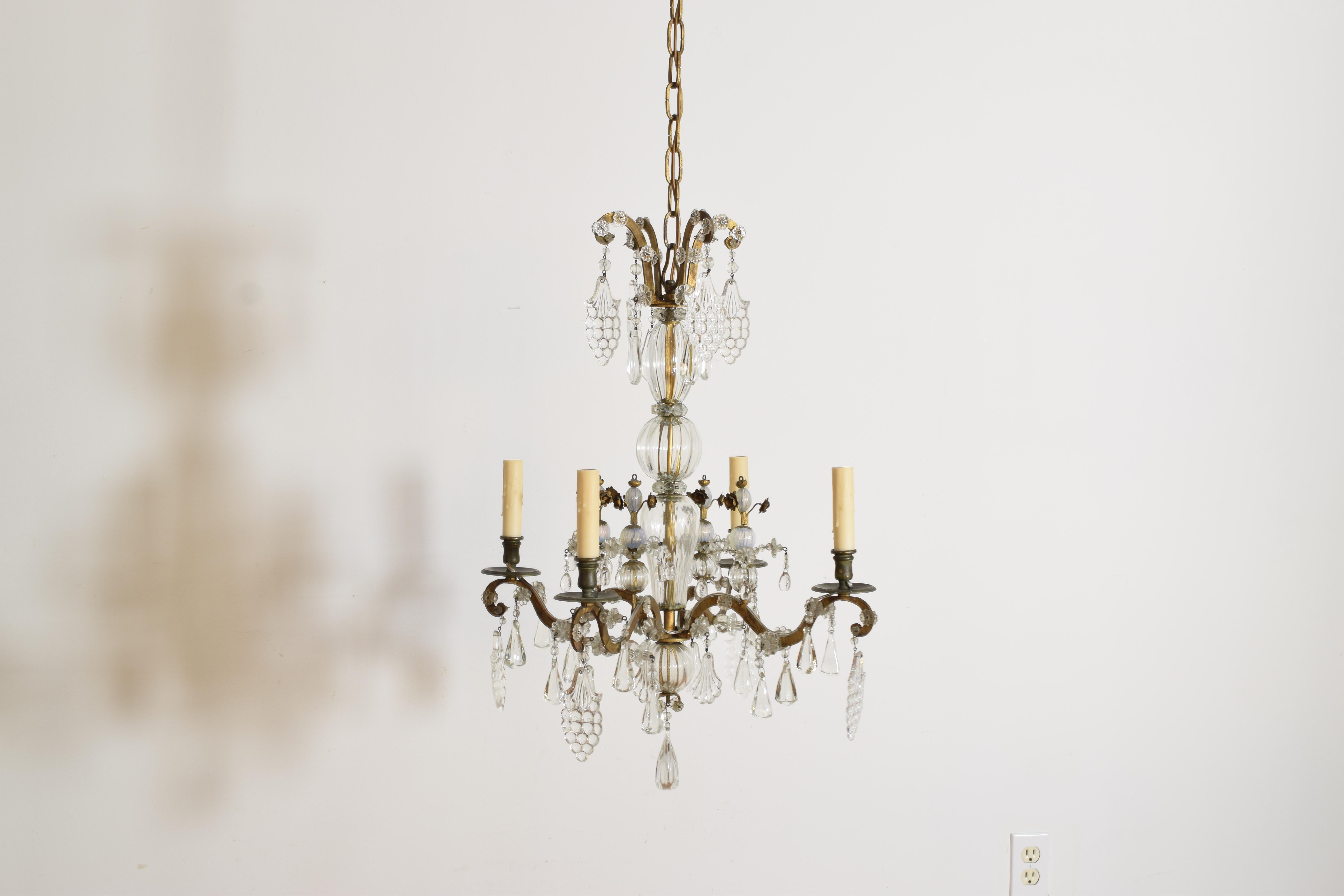 the top issuing 4 scrolls wioth hanging pendants and applied rosettes, the standard surrounded by blown glass balls and issuing 4 scrolling arms (all metal surfaces gilded), the arms topped with blown glass opaque light blue ball towers with