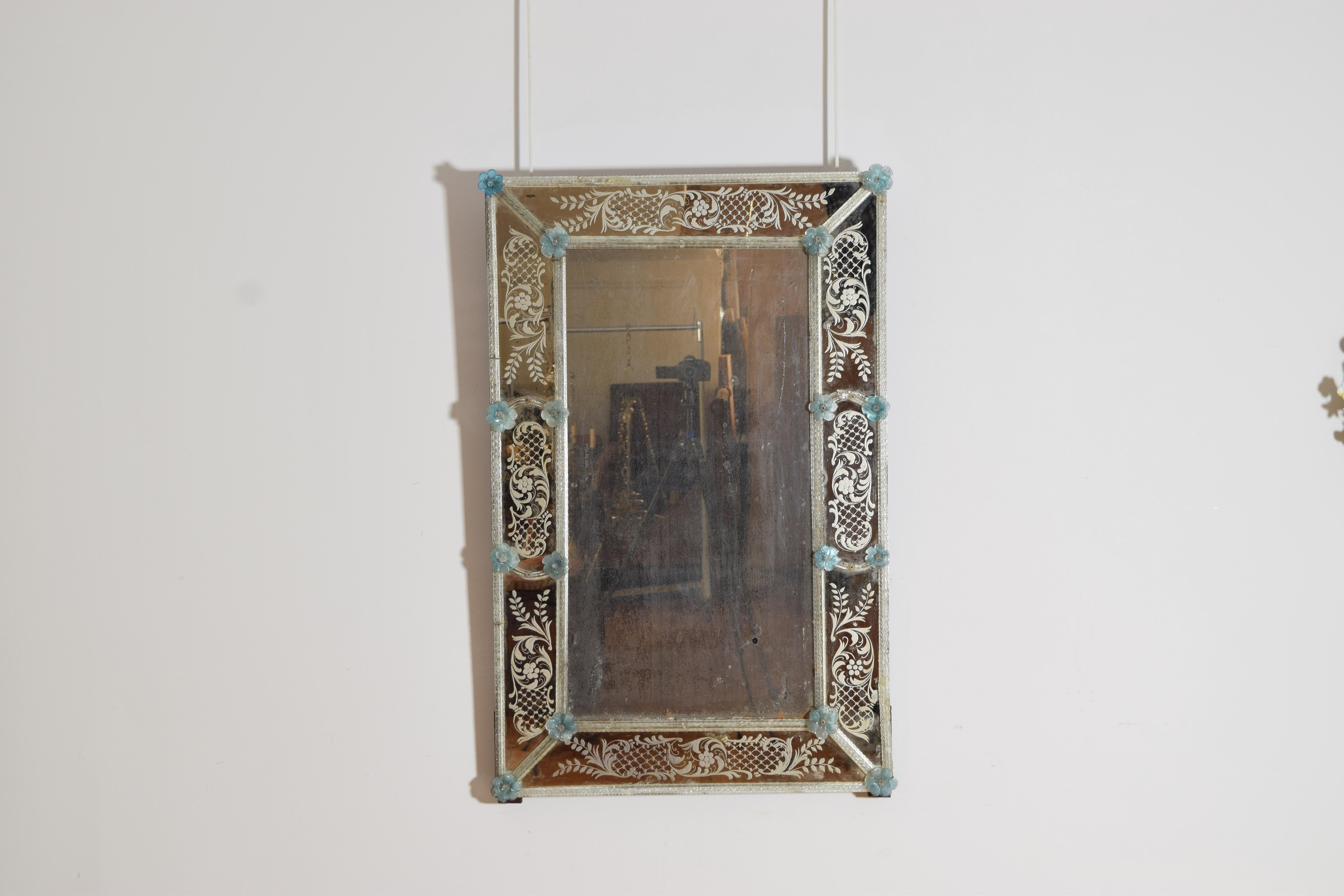 of rectangular for and having an outside border of finely etched patterns surmounted by blown glass rods, the rods accented by blue blown glass flowers, a collaborative effort from drawing a horizontal line from Piemontese and Venezia regions of